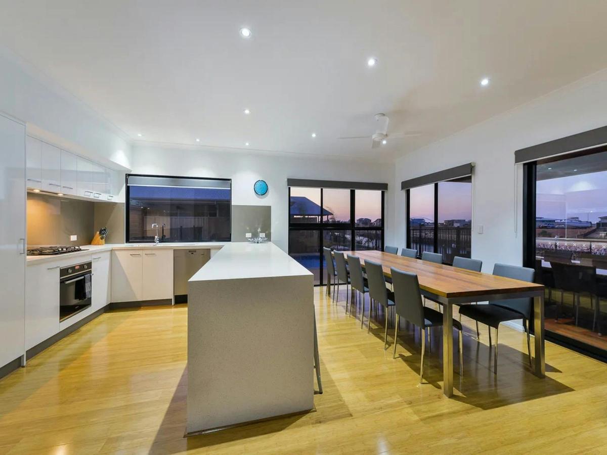 Modern kitchen and dining area with view and seating for a group
