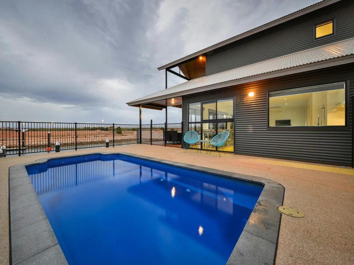 Private waterfront pool with marina views and spacious outdoor living