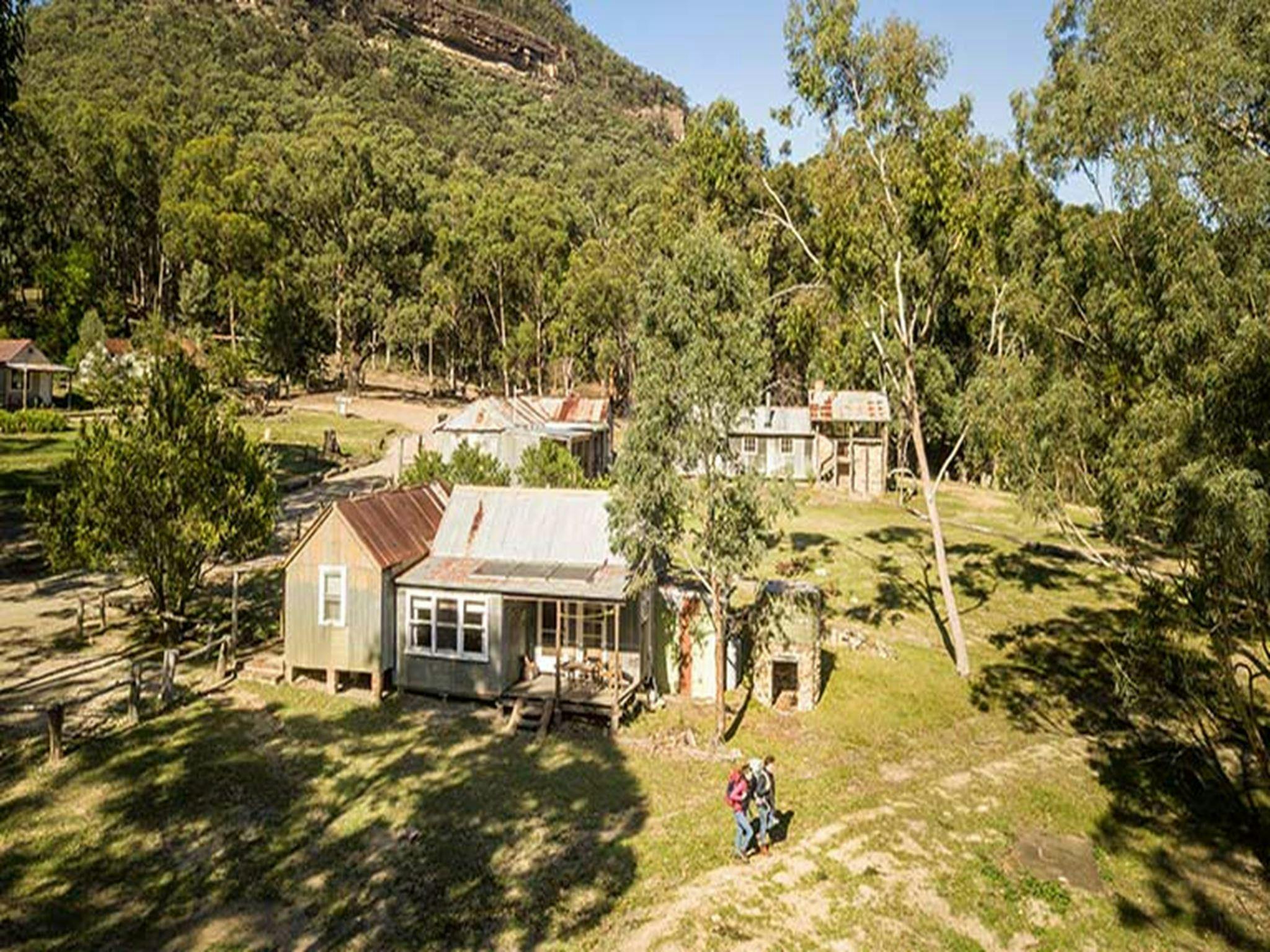 A couple set out on a hike from Slippery Norris Cottage in Yerranderie Regional Park. Photo: John