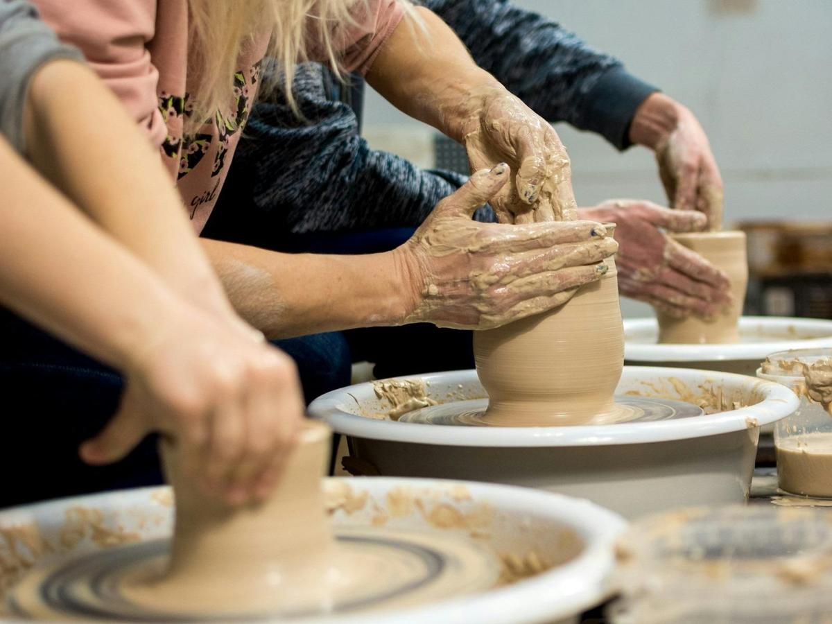 Throwing clay on a potters wheel