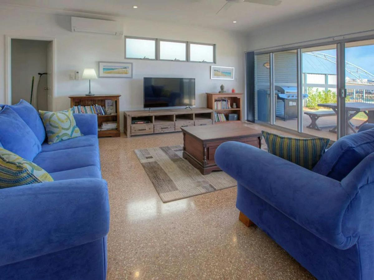 The inviting living room features comfortable seating and direct access to the waterfront deck