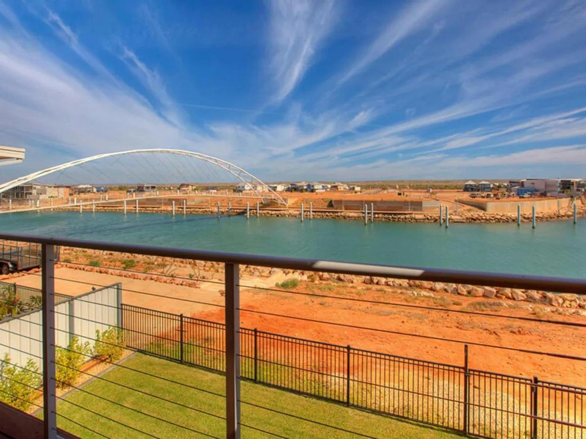 Enjoy sweeping waterfront views from the balcony overlooking the marina and nearby bridge