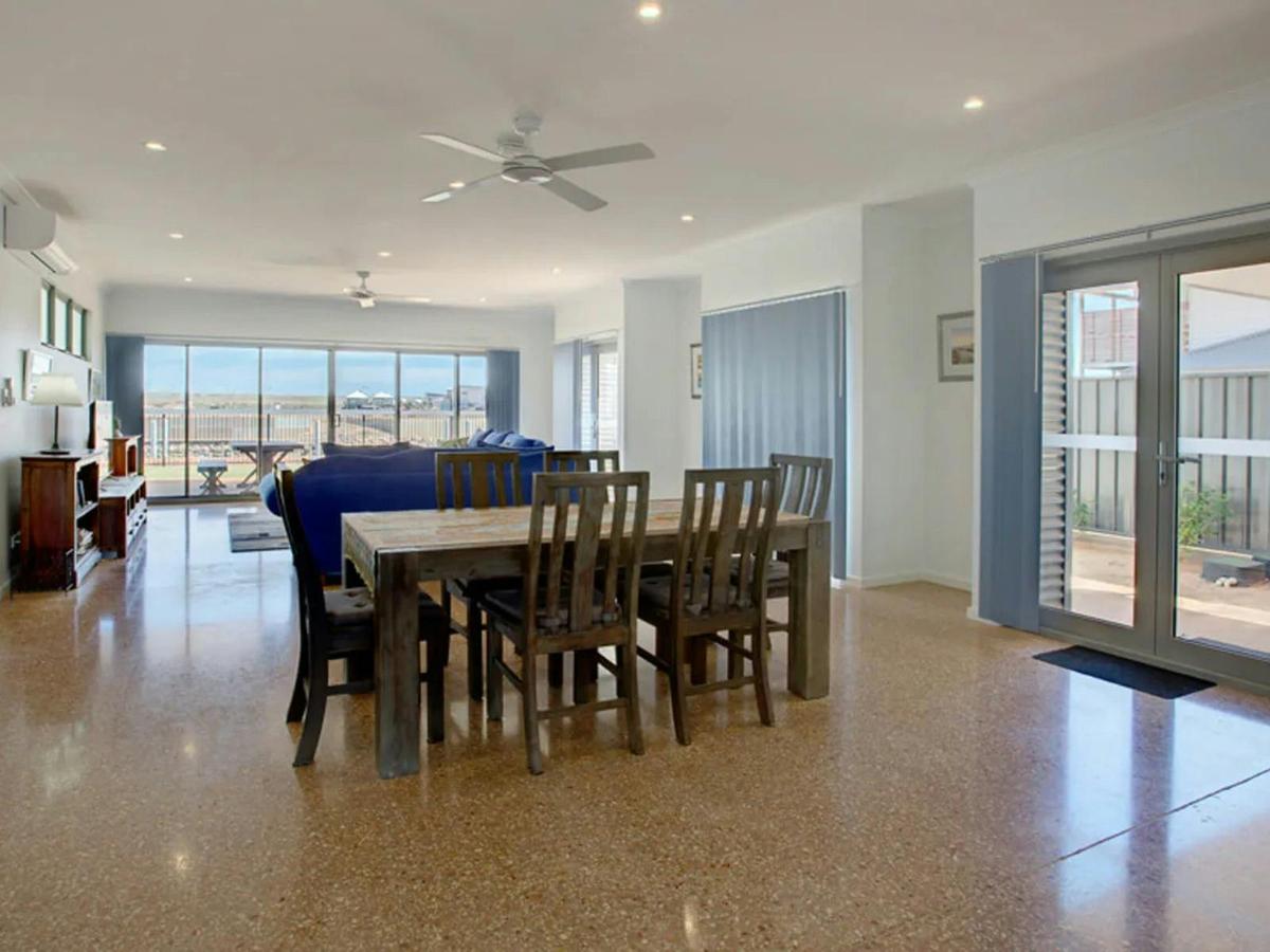 The bright open dining area connects naturally with the living room and outdoor spaces