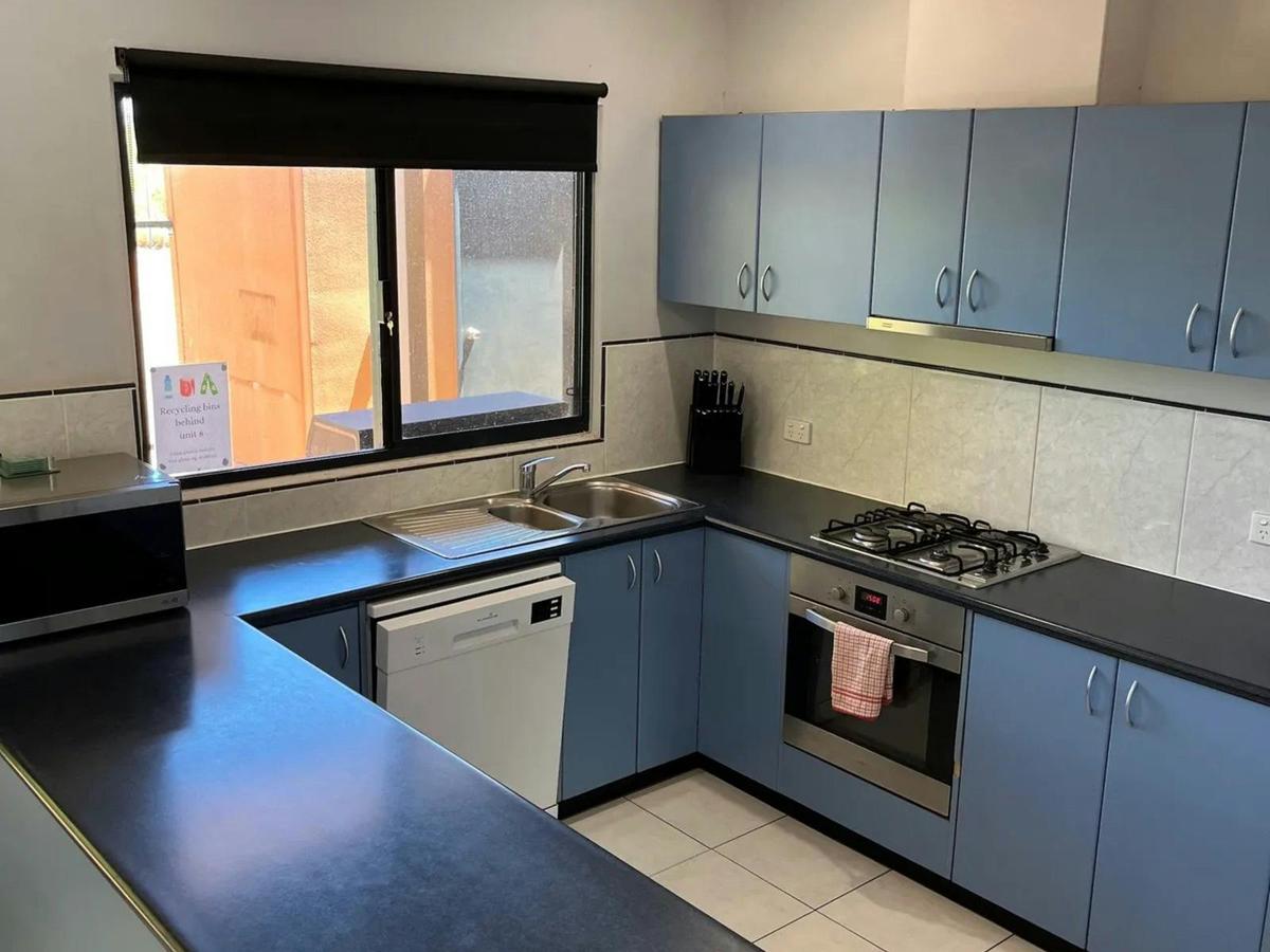 The fully equipped kitchen offers generous counter space and everything needed for your stay