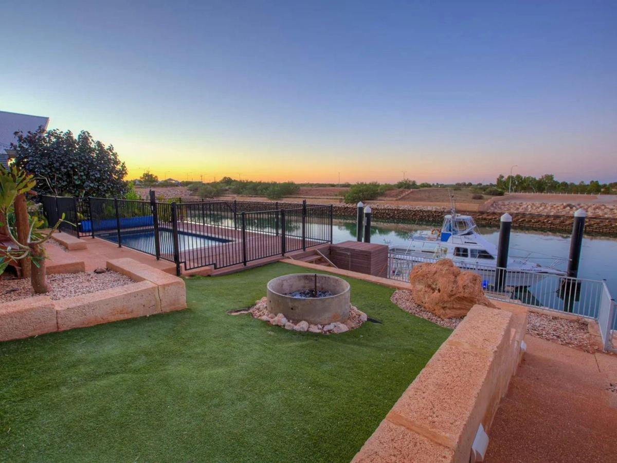The waterfront yard offers peaceful marina views and a relaxing outdoor gathering space