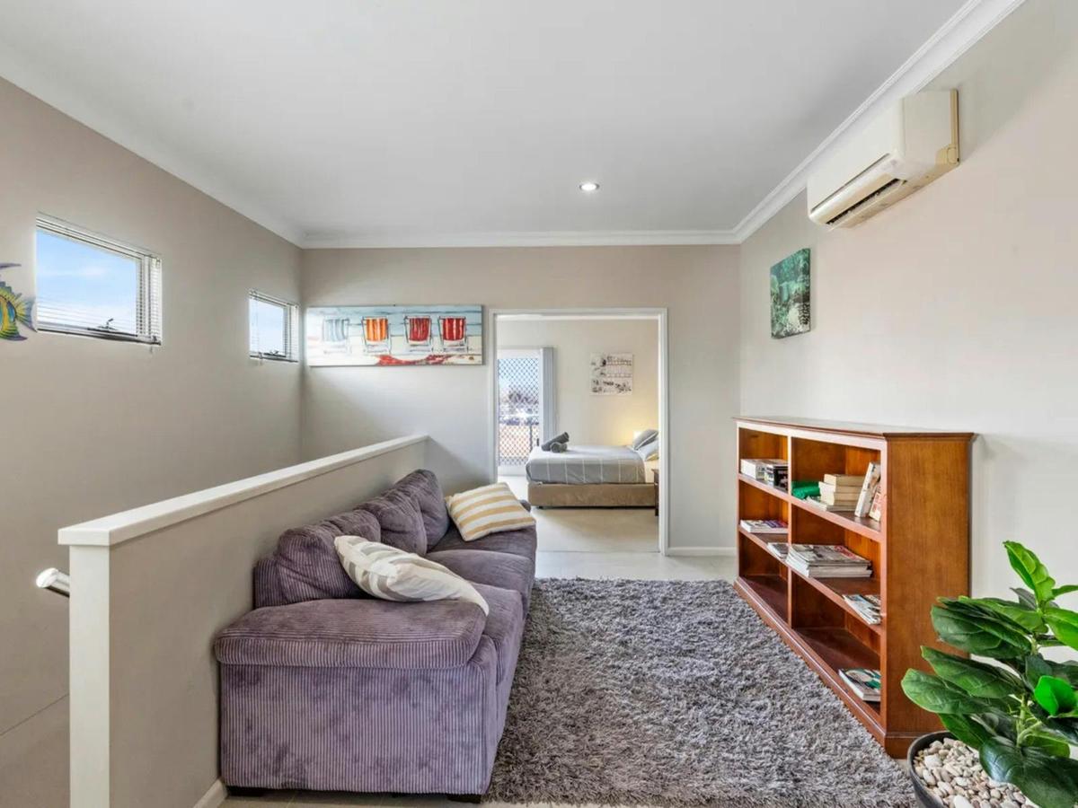 An inviting upstairs lounge offers cozy seating and easy access to the adjoining bedroom