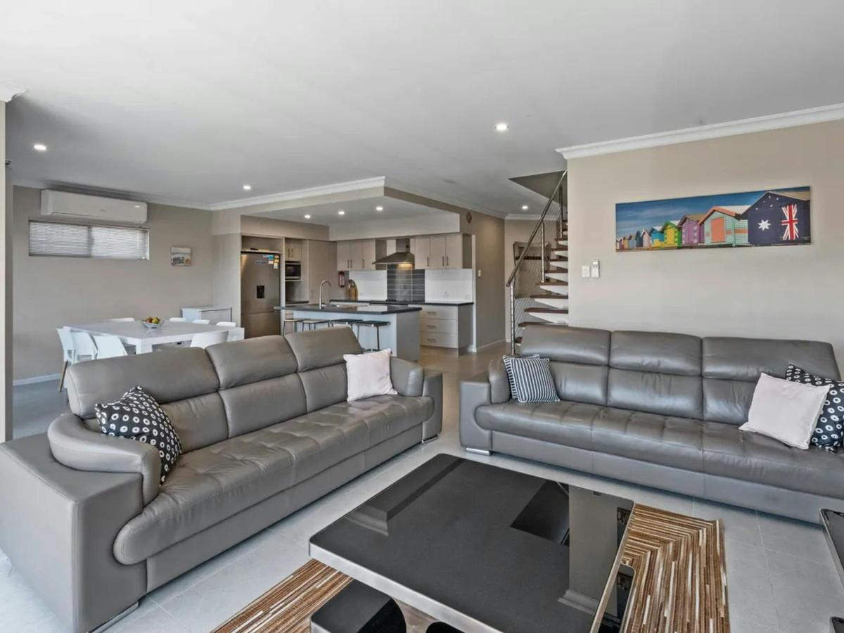 The open living area features comfortable seating and a seamless connection to the kitchen