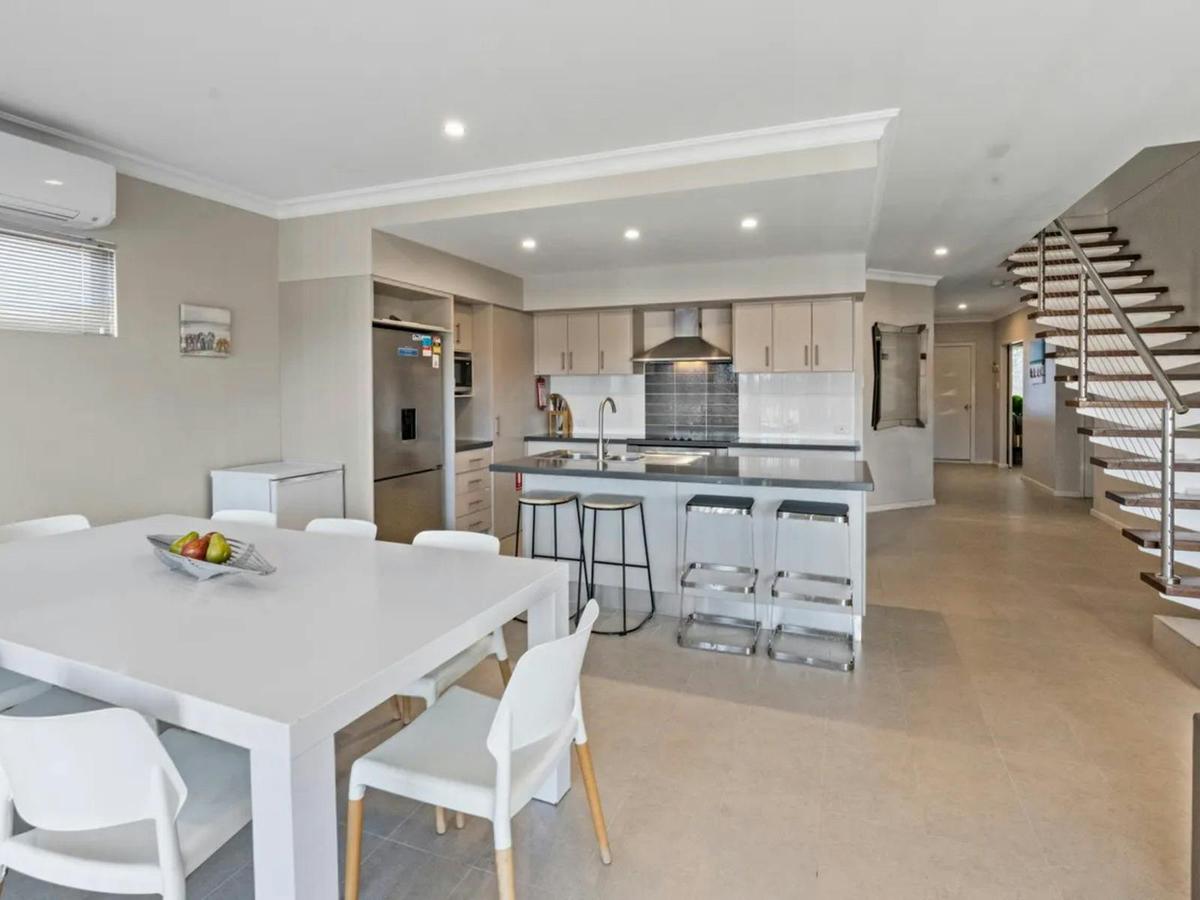 The open dining and kitchen area offers a spacious layout for meals and shared time together