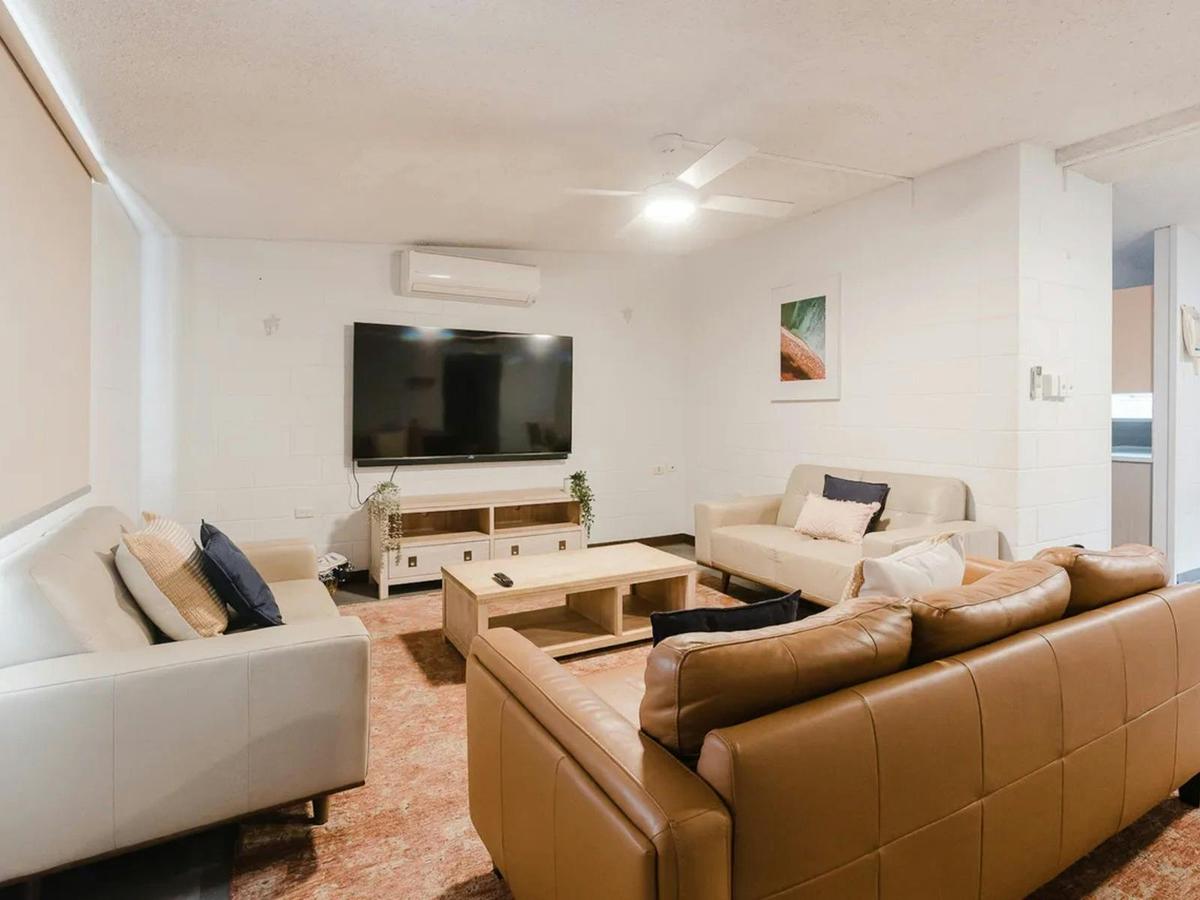 The spacious living room includes generous seating and a television for relaxing together