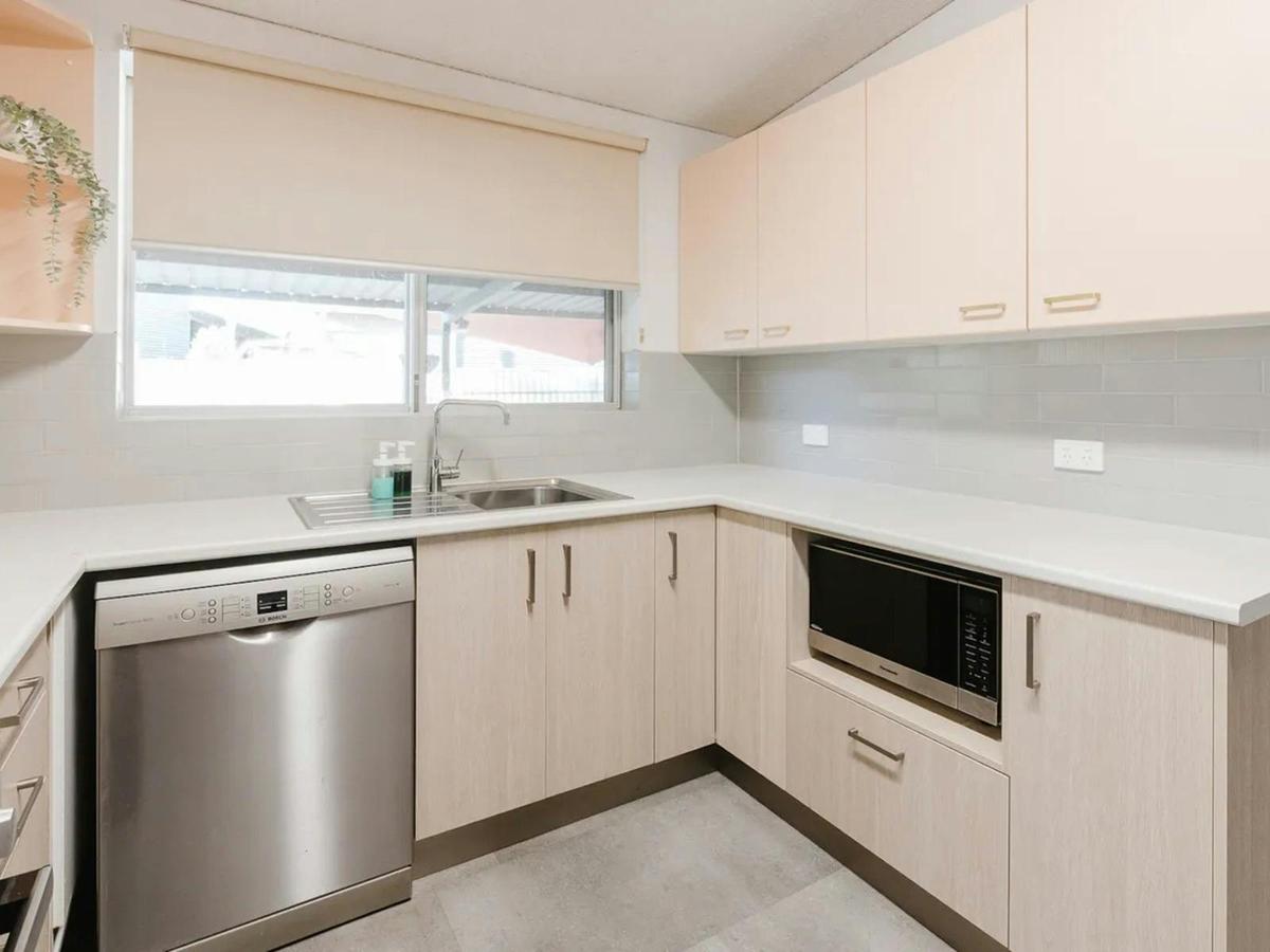 The modern kitchen includes ample cabinetry, quality appliances, and generous counter space