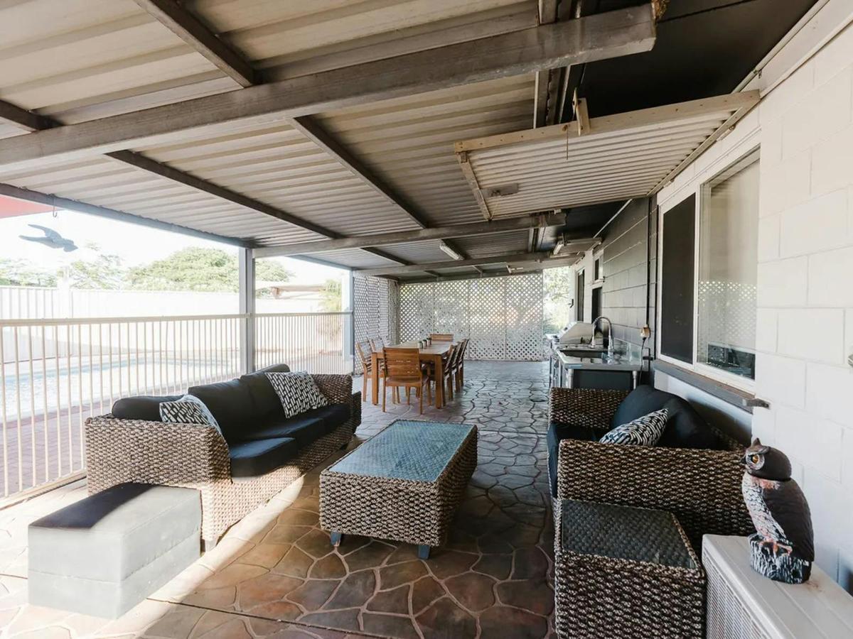 The expansive covered patio offers comfortable seating and plenty of room for outdoor dining