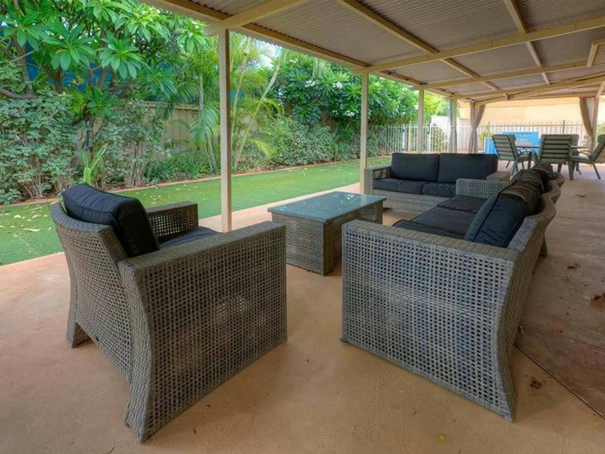 A large covered patio provides comfortable outdoor seating for relaxing and entertaining