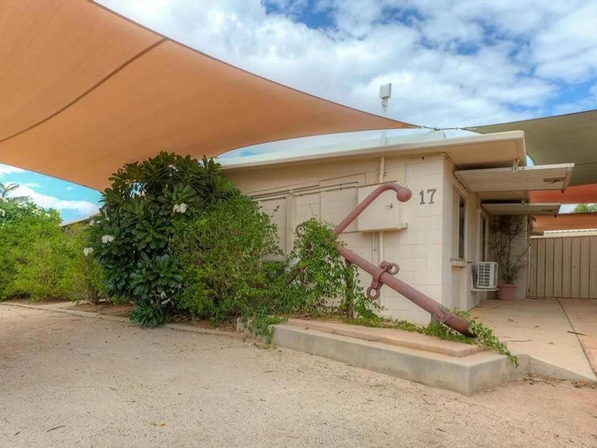 The private home exterior welcomes guests with covered parking and a shaded entrance