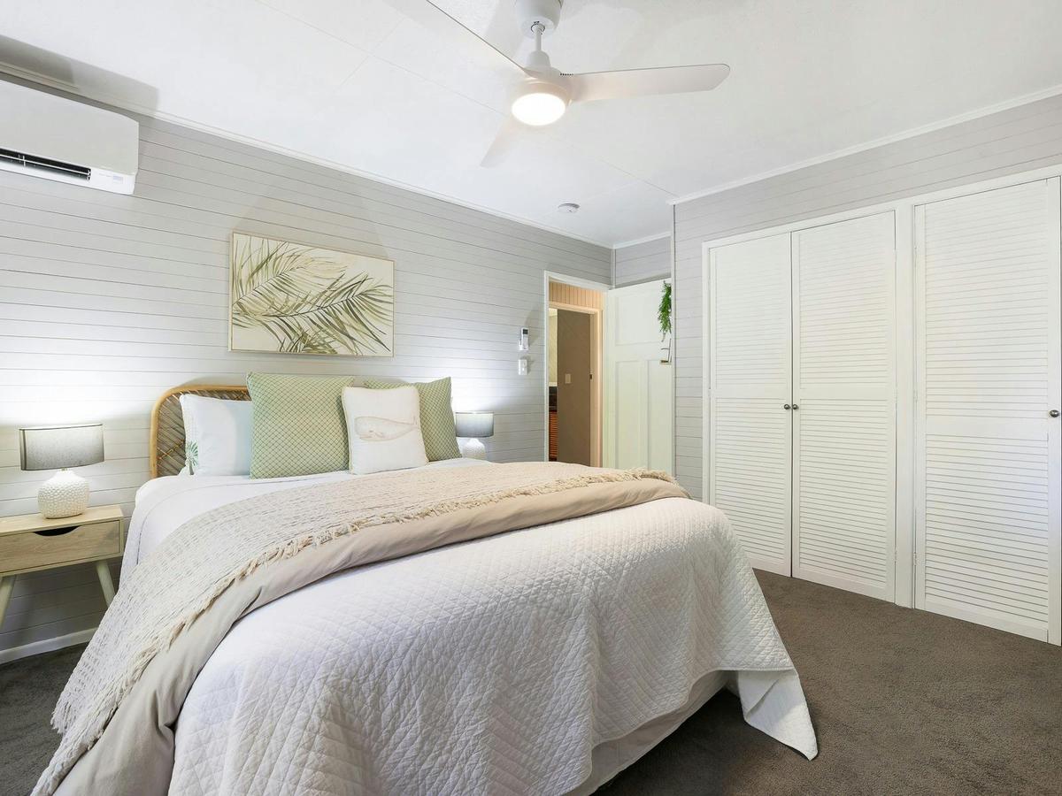 Large second bedroom with queen bed, ceiling fan and aircon, built in robes