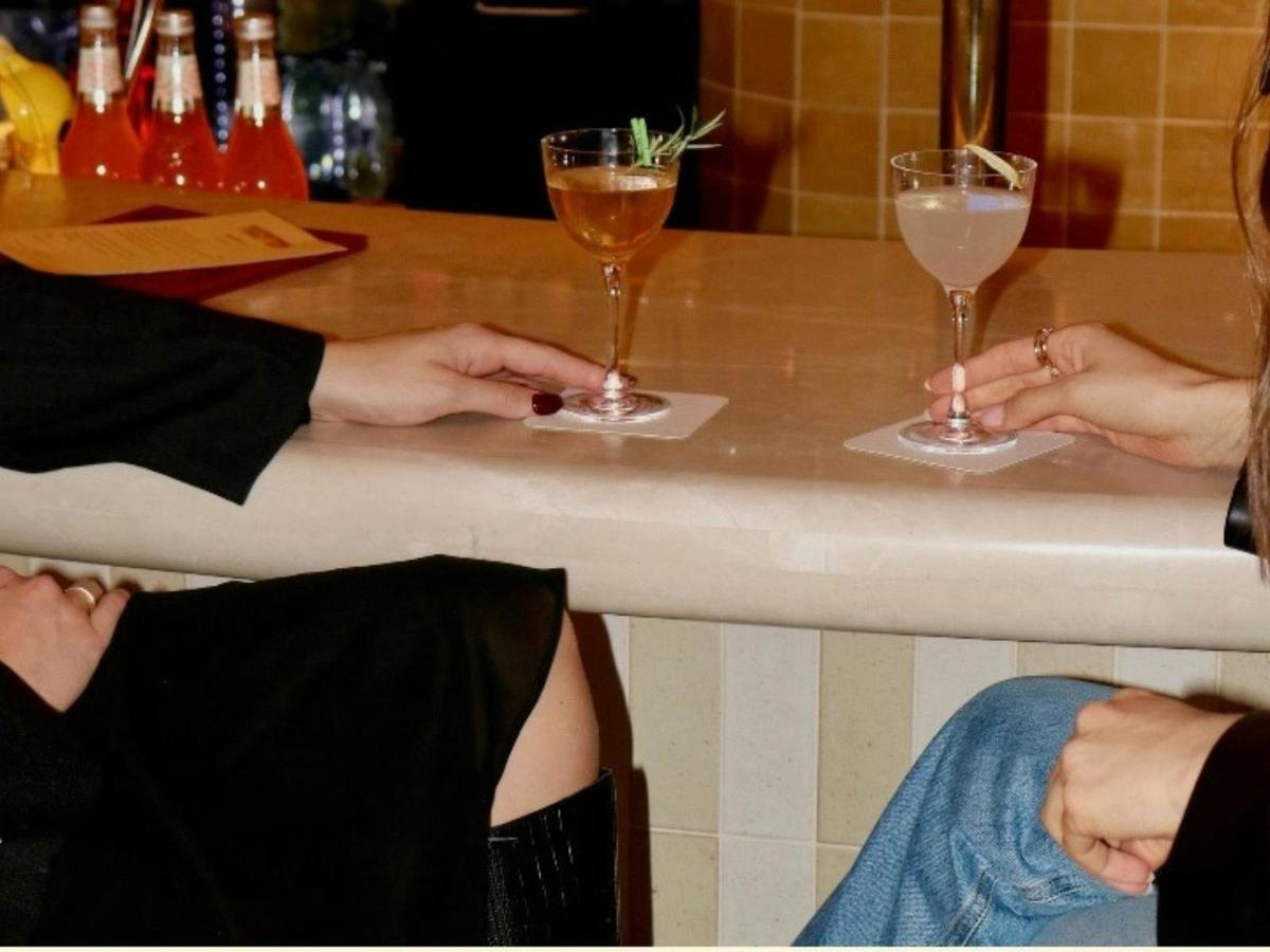 Girls sitting a bar with martinis