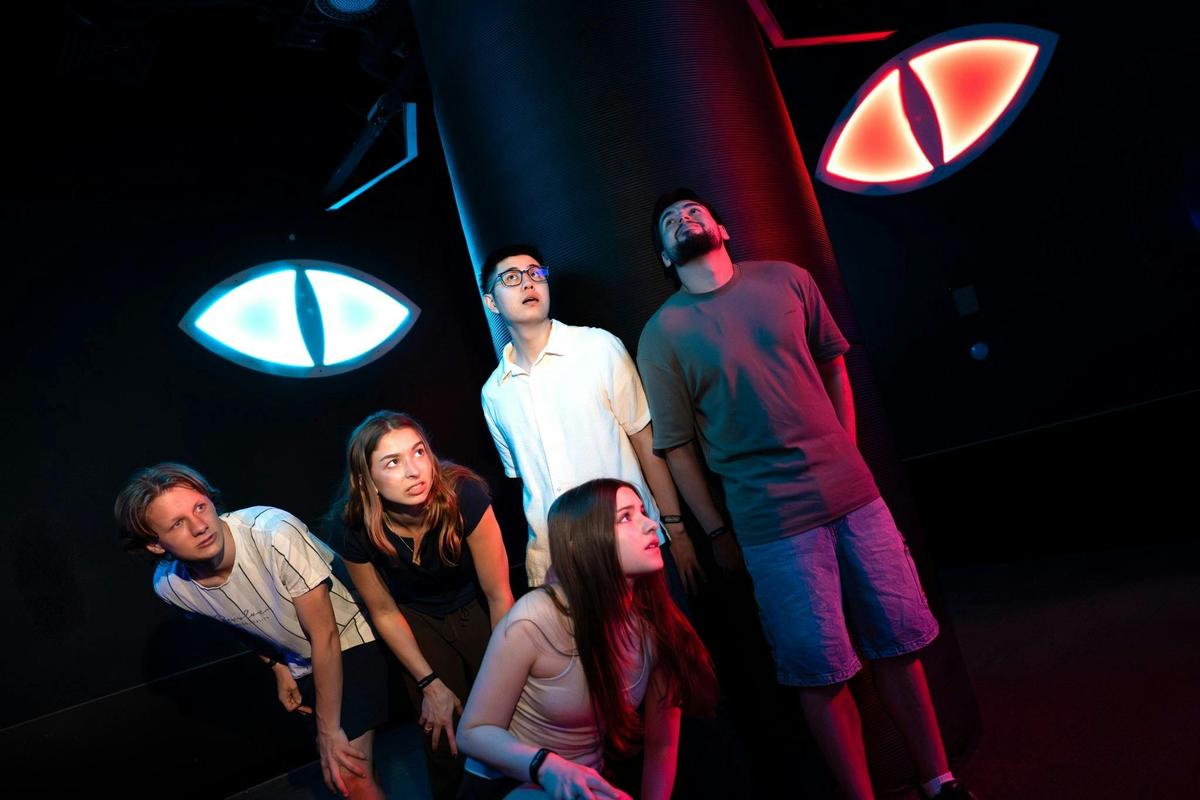 Friends test their reactions and teamwork in the Evil Eyes challenge at Power Play Sydney.