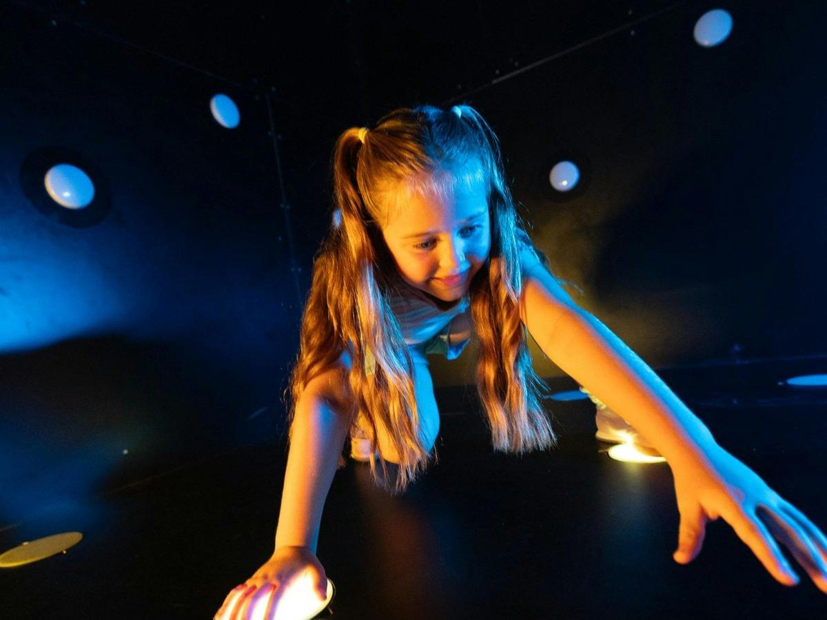 Kids enjoying an exciting interactive light-up wall challenge at Power Play Sydney.