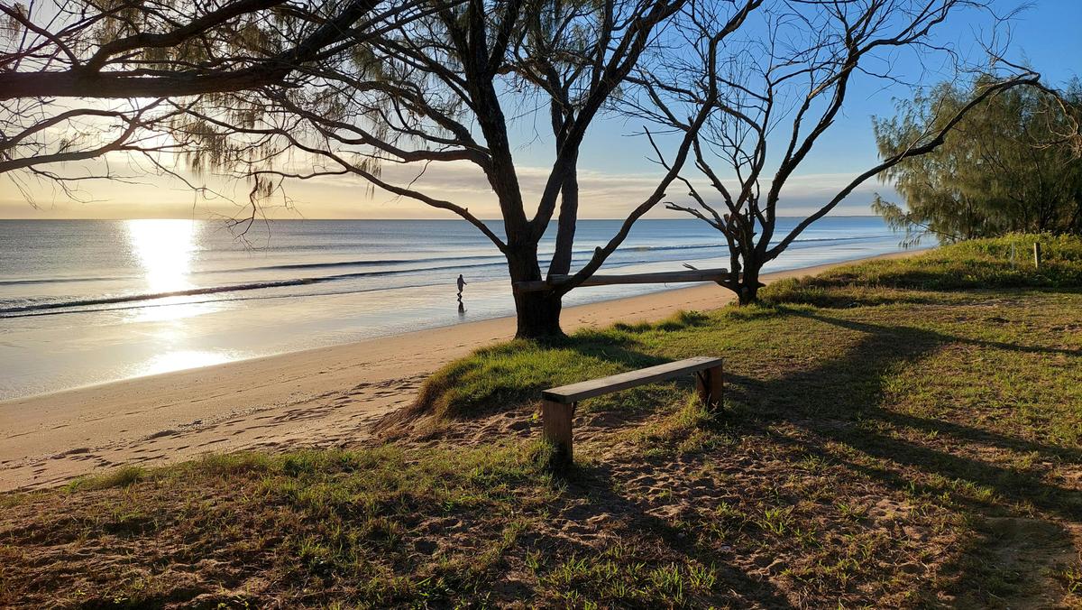 Sit and watch the sun rise over the calm wate rs of the Coral Sea at Moore Park Beach