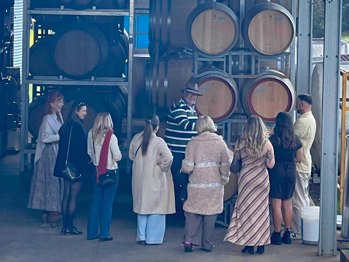 Guests inside Hunter Wine Lab’s working winery during the Growing to Glass tour.