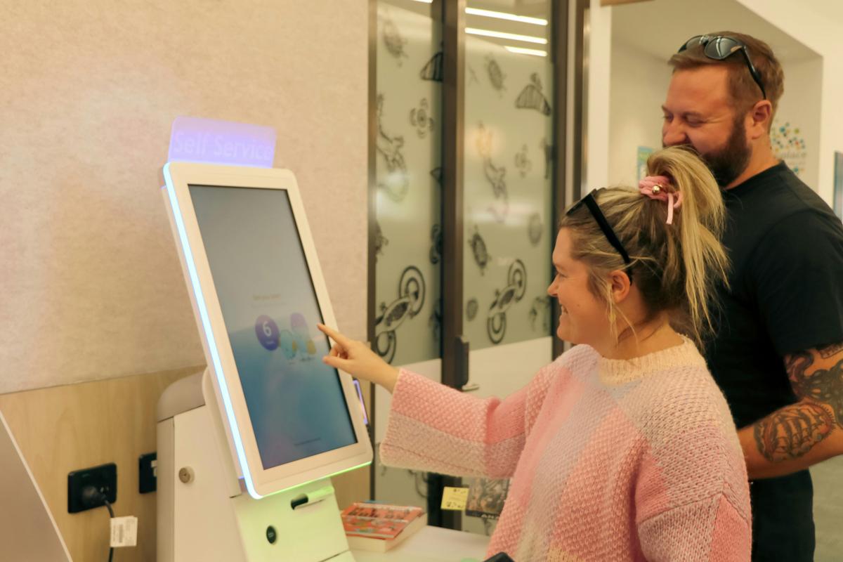 A person using the self check out staition.