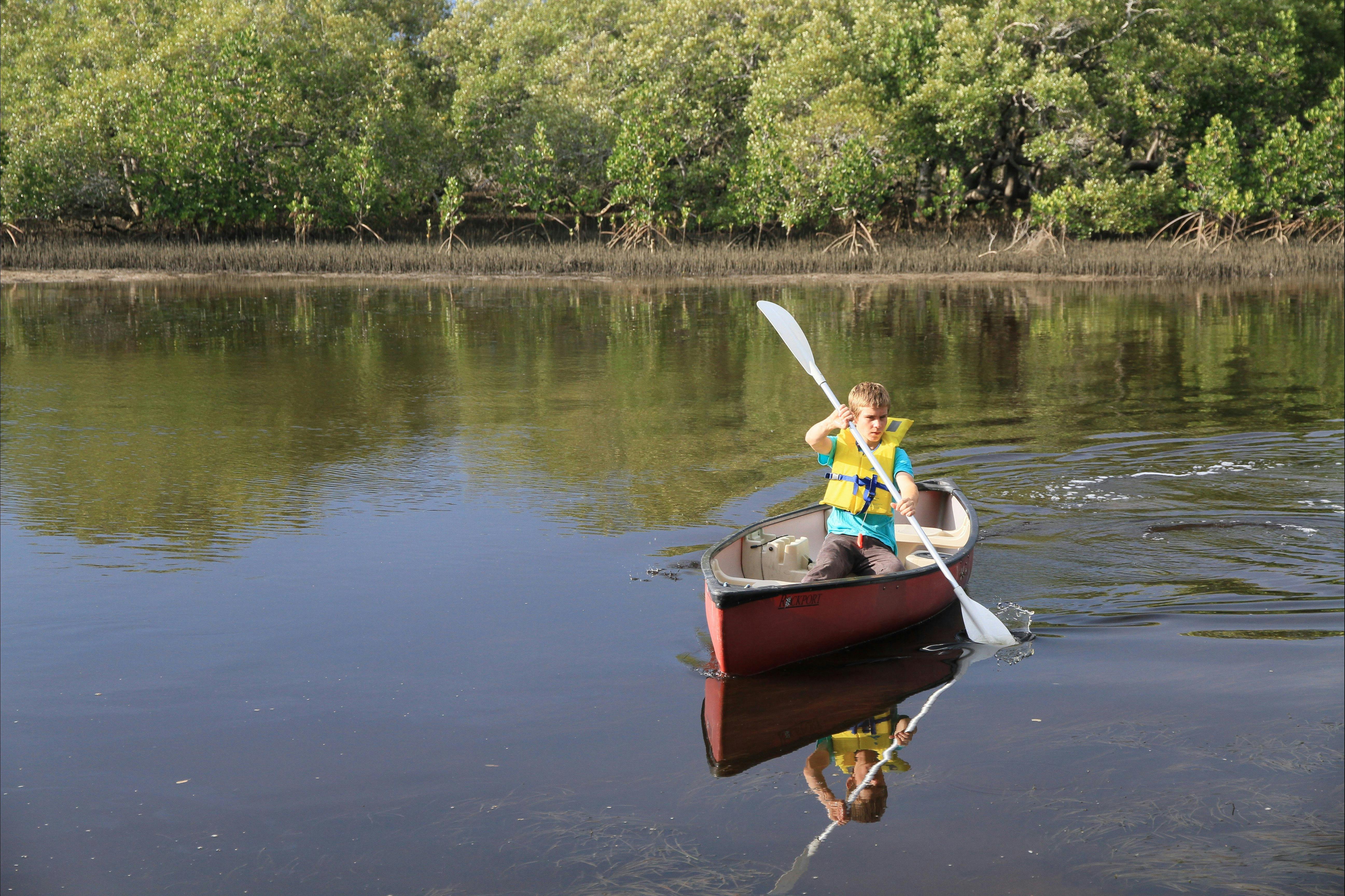 Person canoeing on river