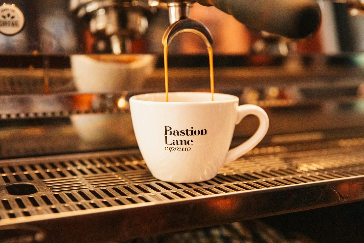 Coffee cup being filled at cafe