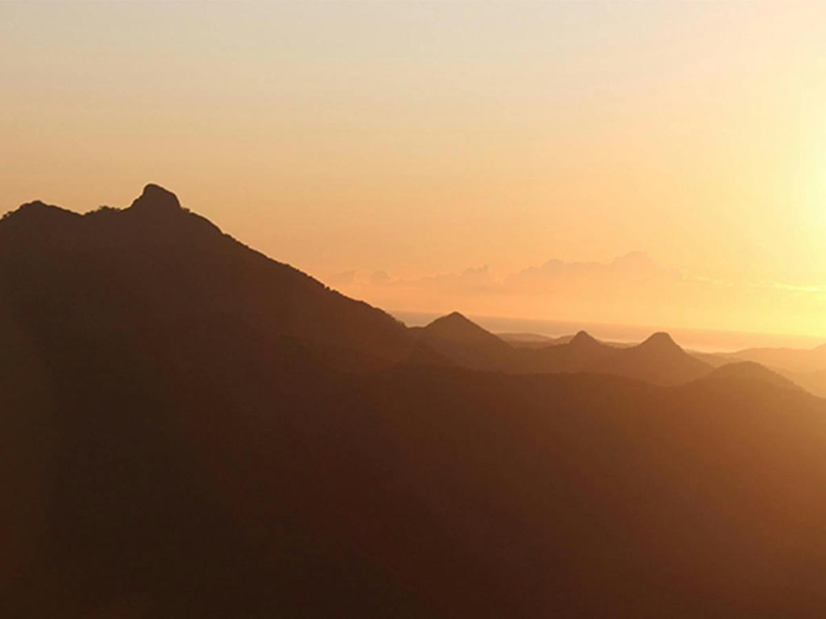 Silhouette of Wollumbin - Mount Warning as the sun rises over the Tweed Valley, seen from Blackbutt