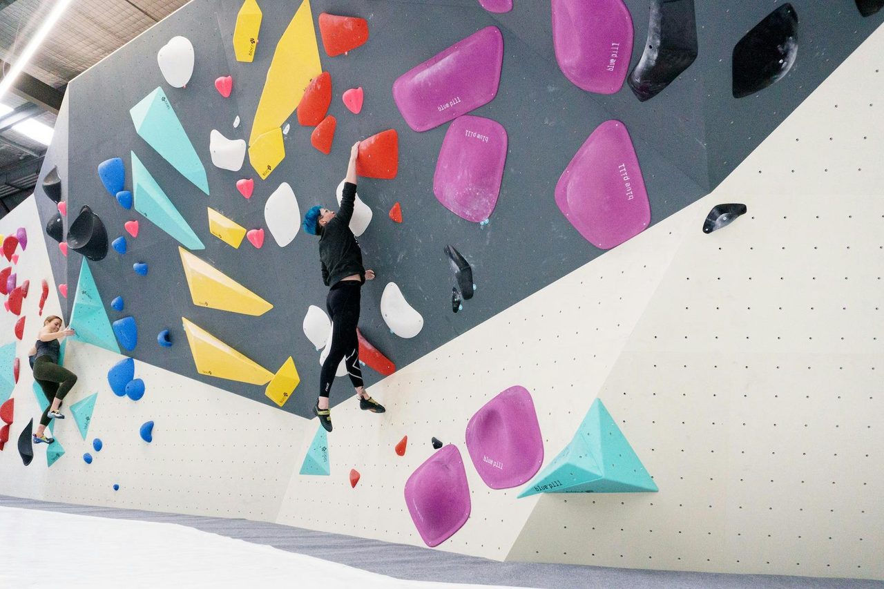 a climber is leaping towards a hold