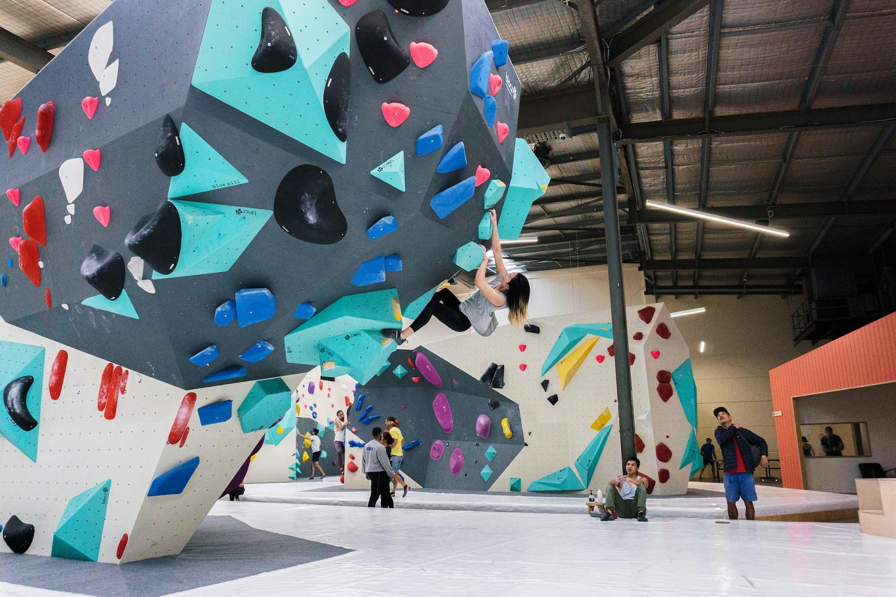 a climber is climbing on an overhung wall