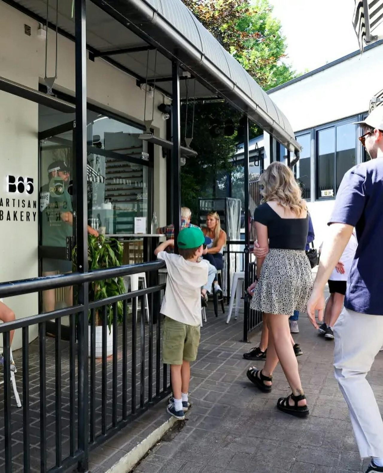 People outside bakery waiting