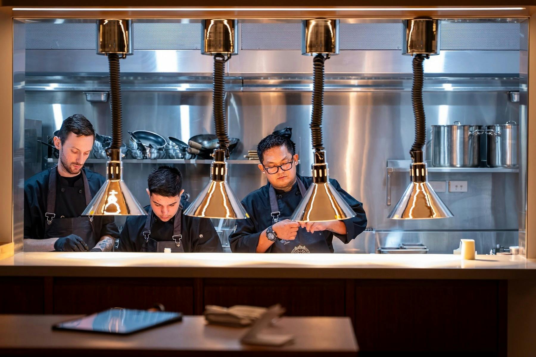 Chefs plating up in kitchen