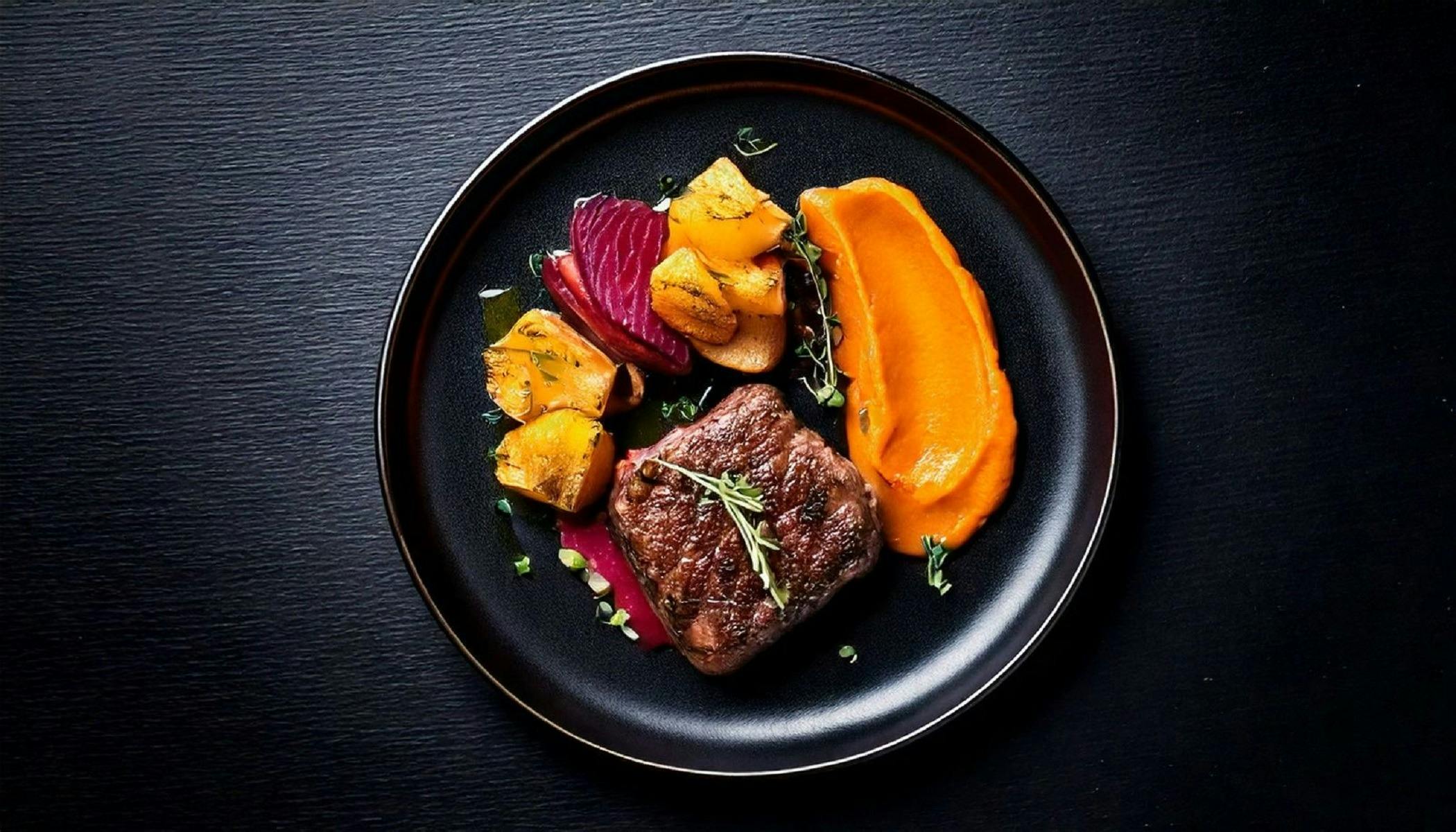 Over head of  fusion plate with Steak with sides