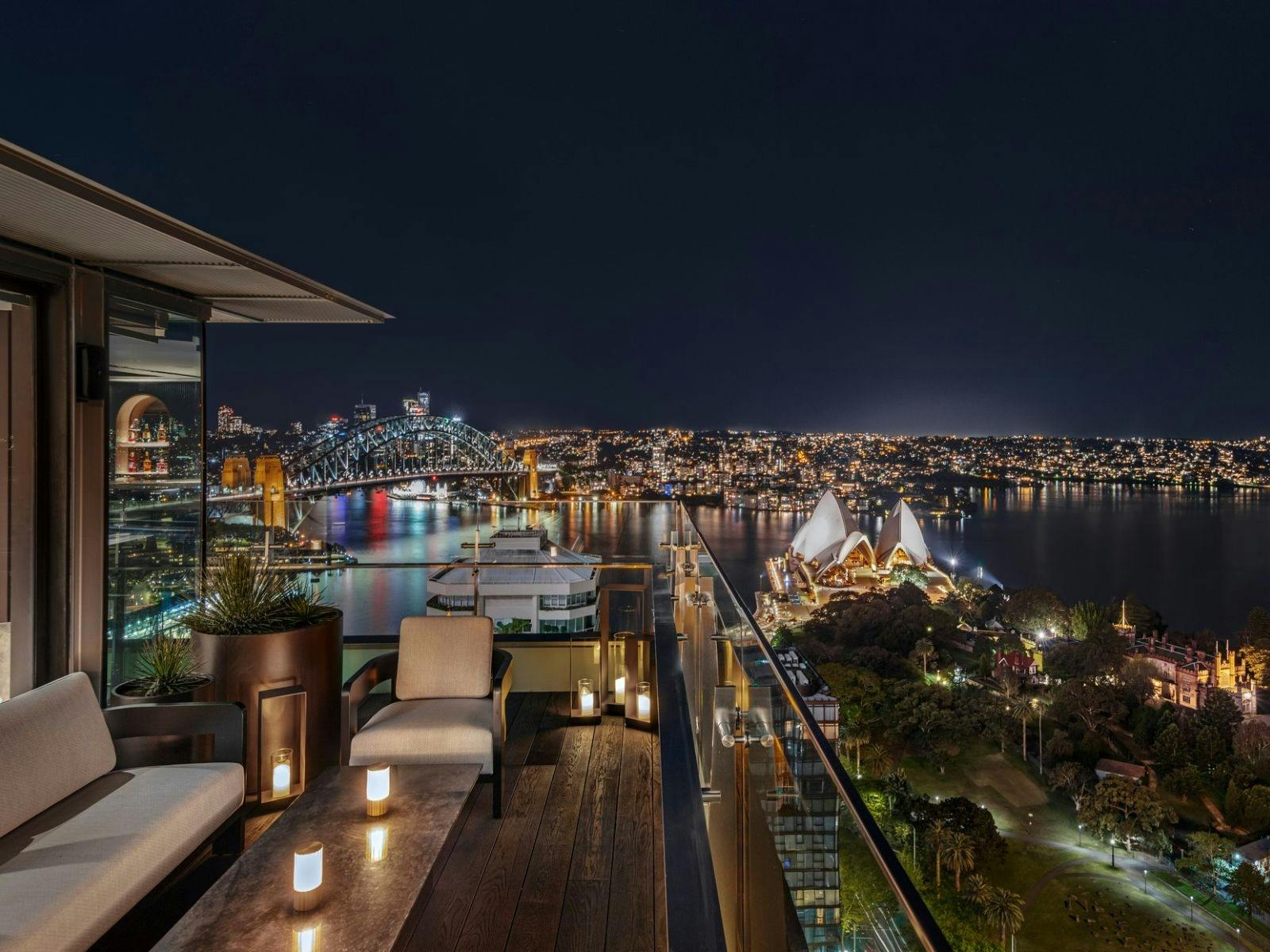 Nighttime view of Sydney Opera House and Harbour from rooftop terrace