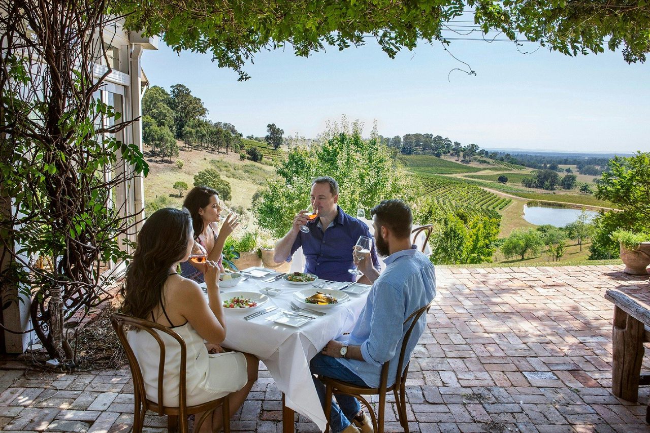 Friends enjoying lunch with scenic vineyard views at Bistro Molines, Hunter Valley