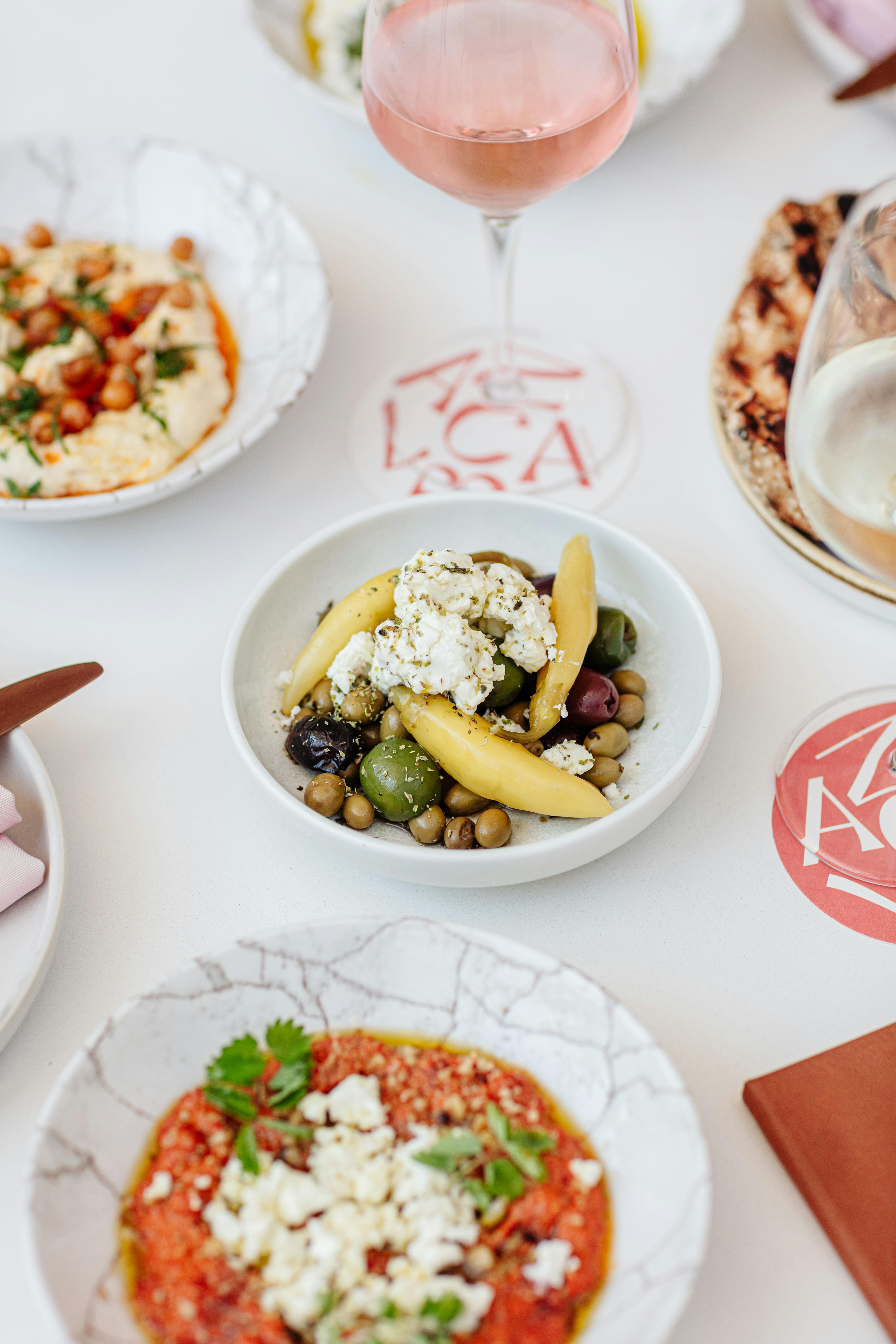 A spread of Mezze with olives, dips and flatbread