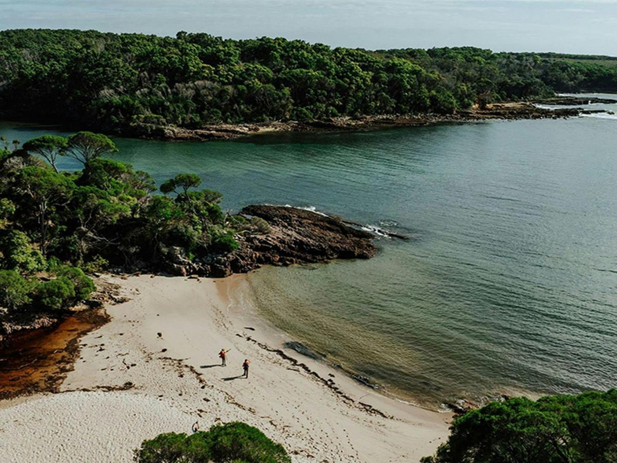 Aerial view of 2 hikers at Bittangabee Bay in Beowa National Park. Credit: Daniel Parsons/DCCEEW
