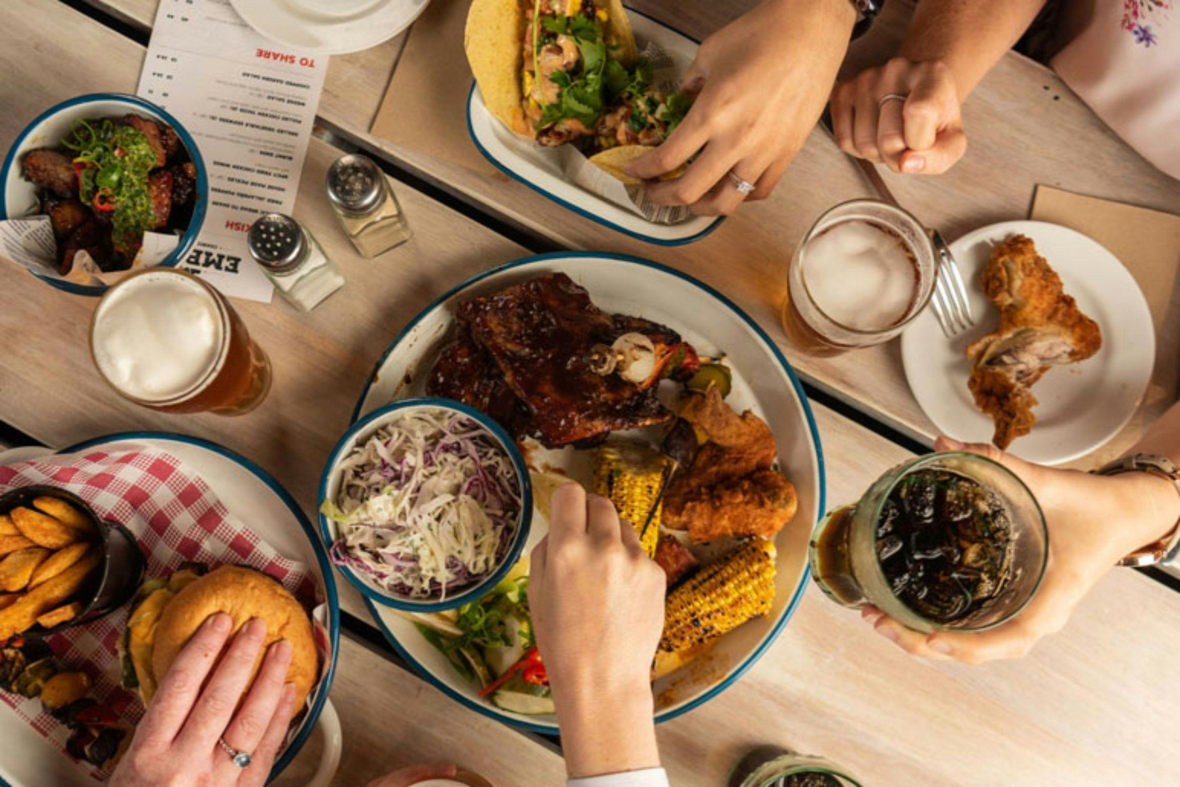 Fingers dipping on the delicious food cuisine