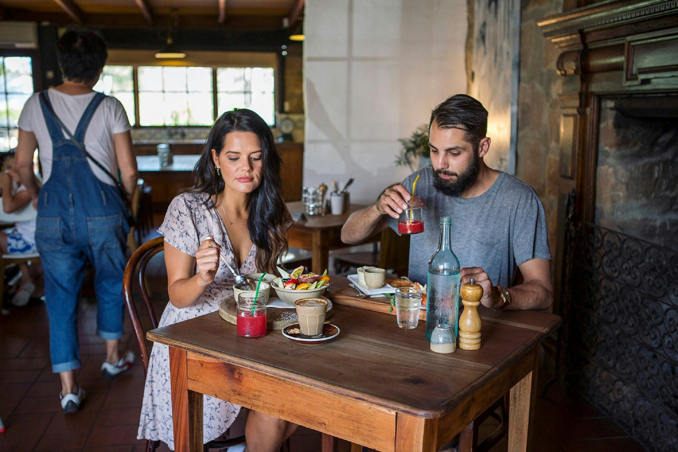 Couple enjoying a relaxed breakfast at Cafe Enzo, Pokolbin
