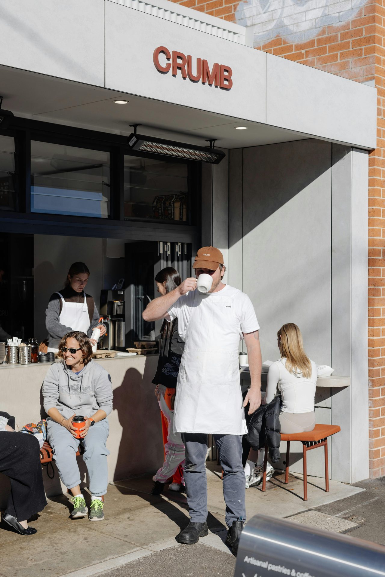 Customers enjoying the sun outside at Crumb