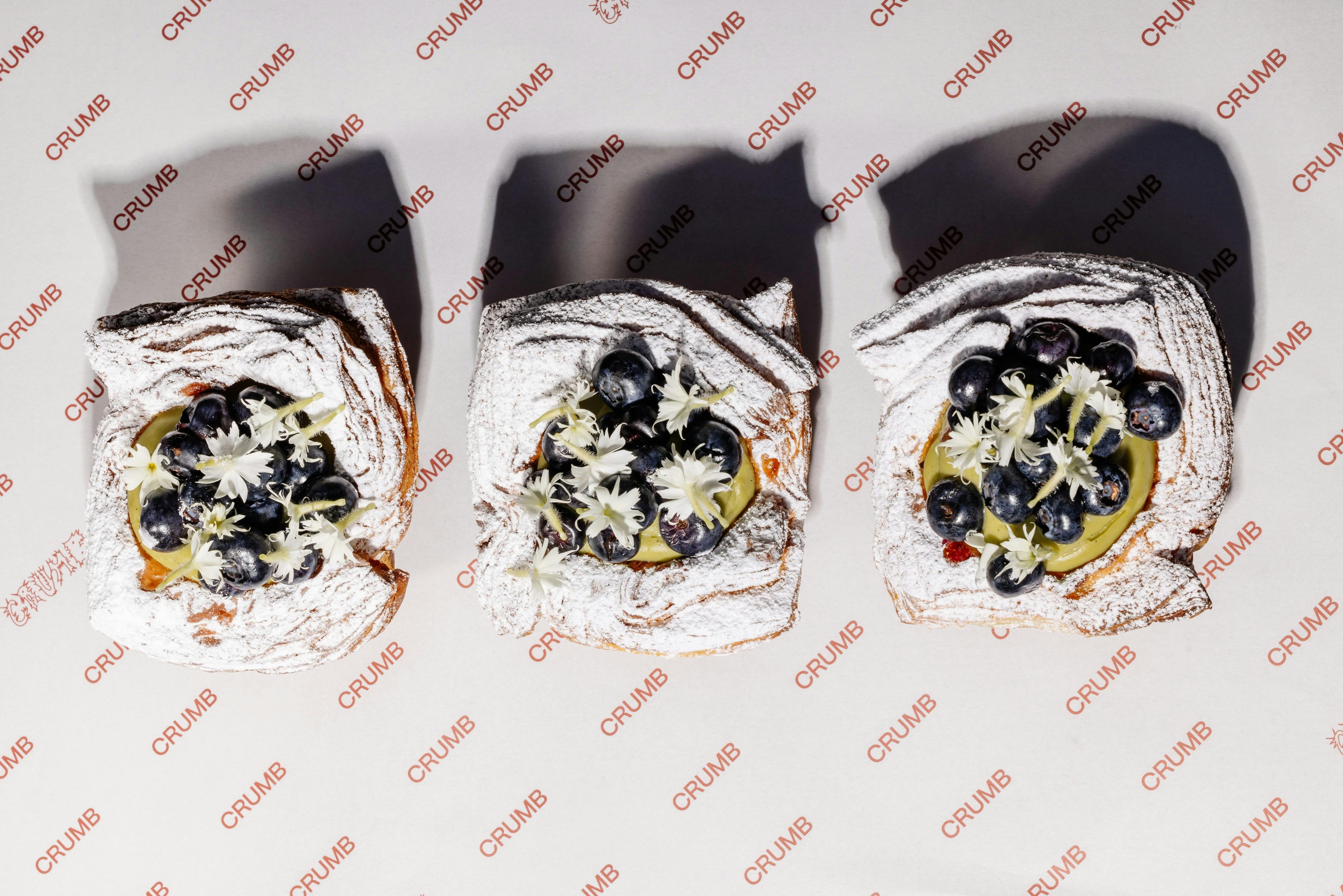 Line up of three blueberry-topped pastries at Crumb