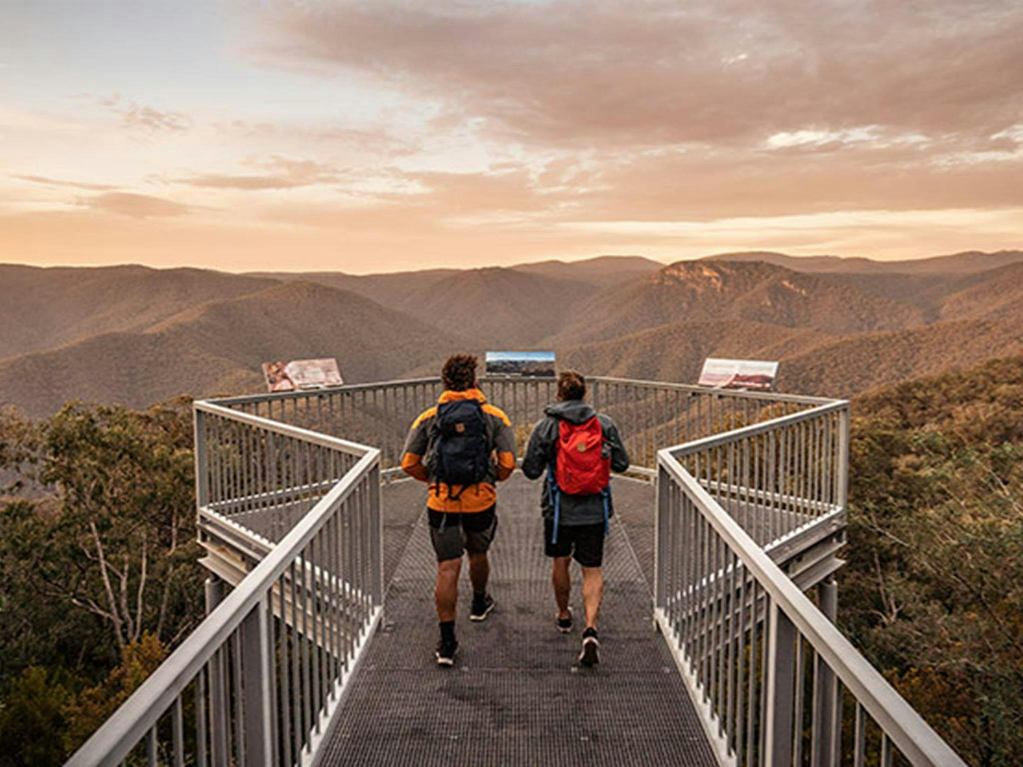 2 men walk to Black Perry lookout at sunrise, Tumut area, Kosciuszko National Park. Photo: Robert