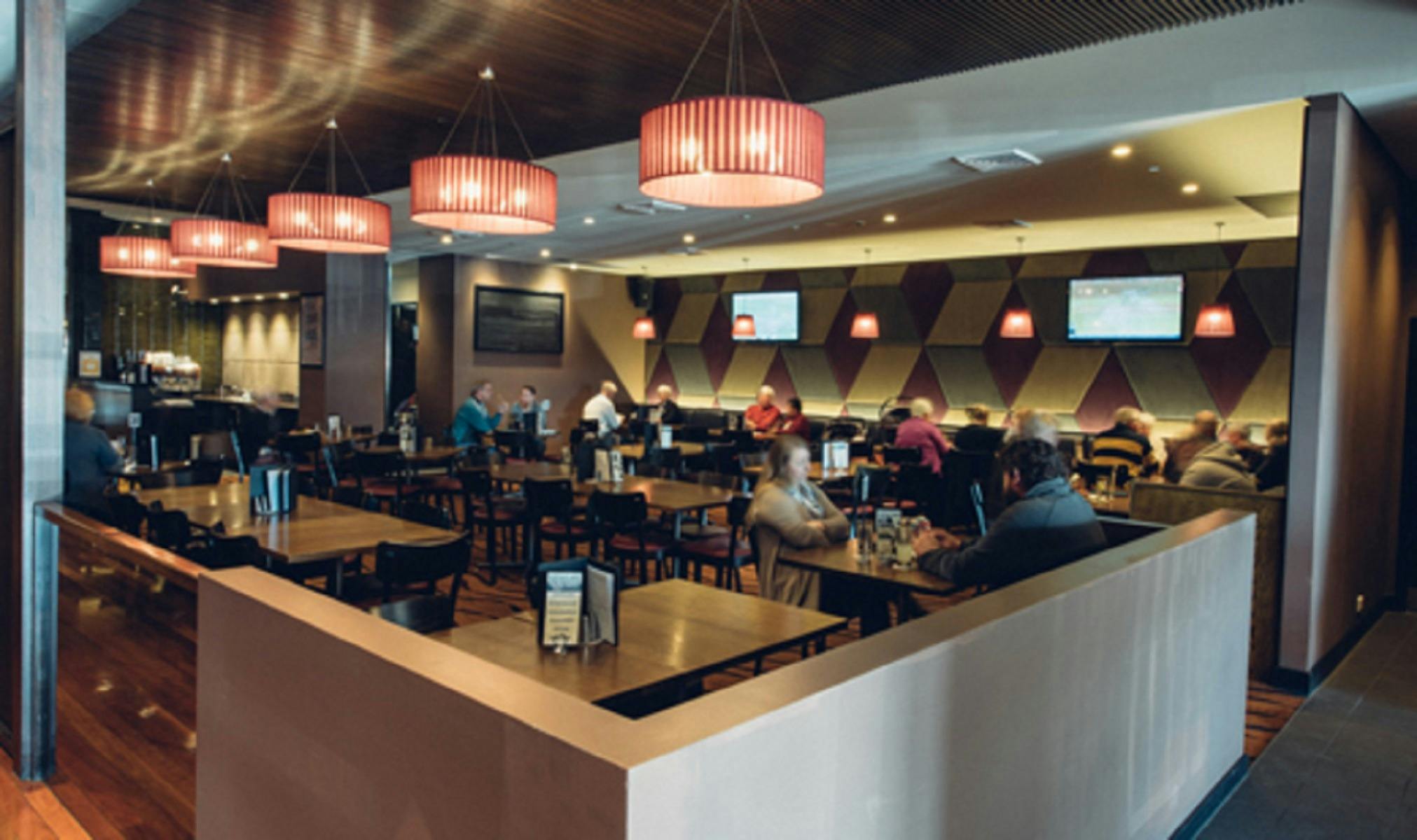 Customers eating in dining area at Camden Hotel