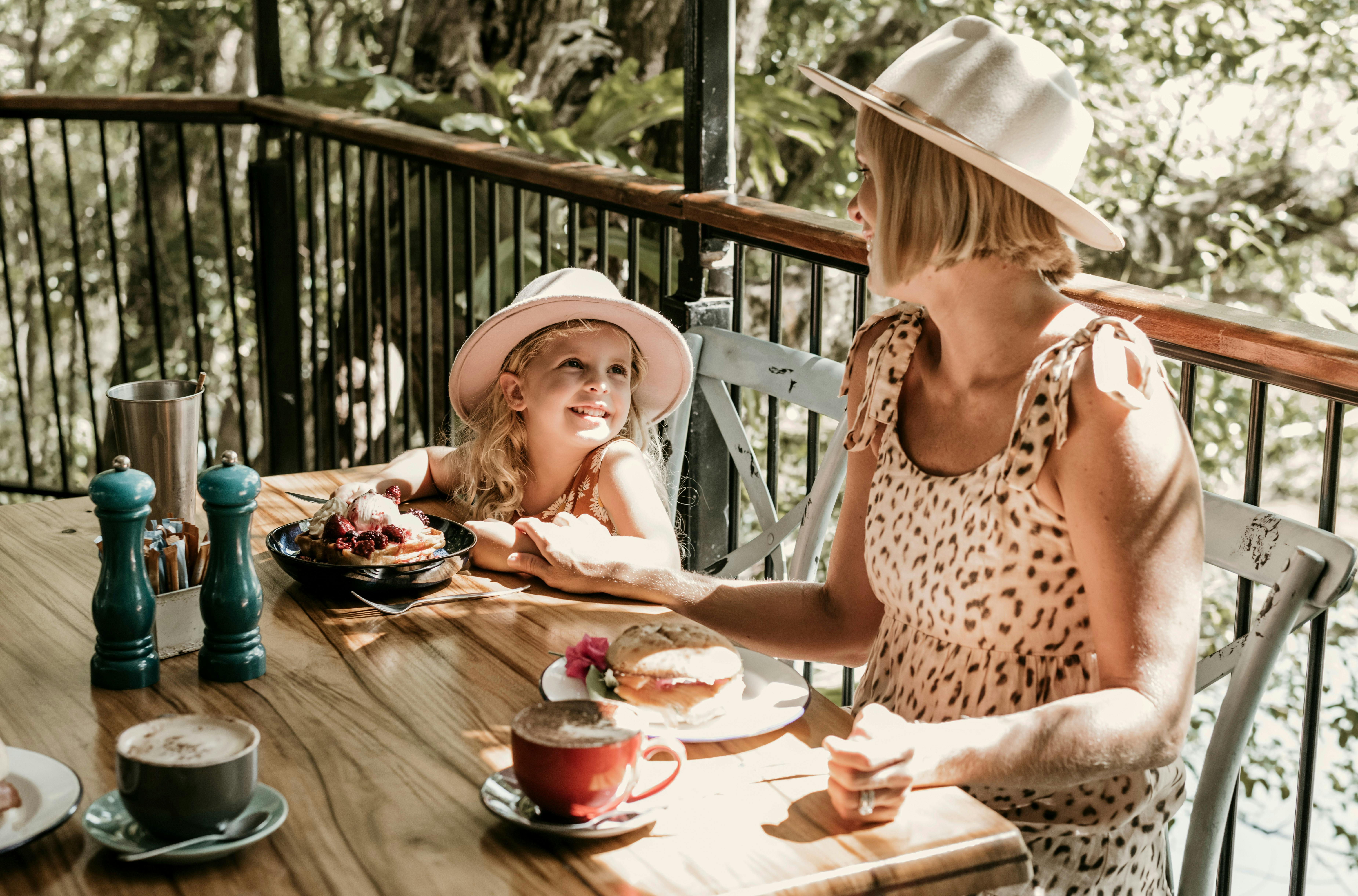 Mum and daughter having breakfast at cafe