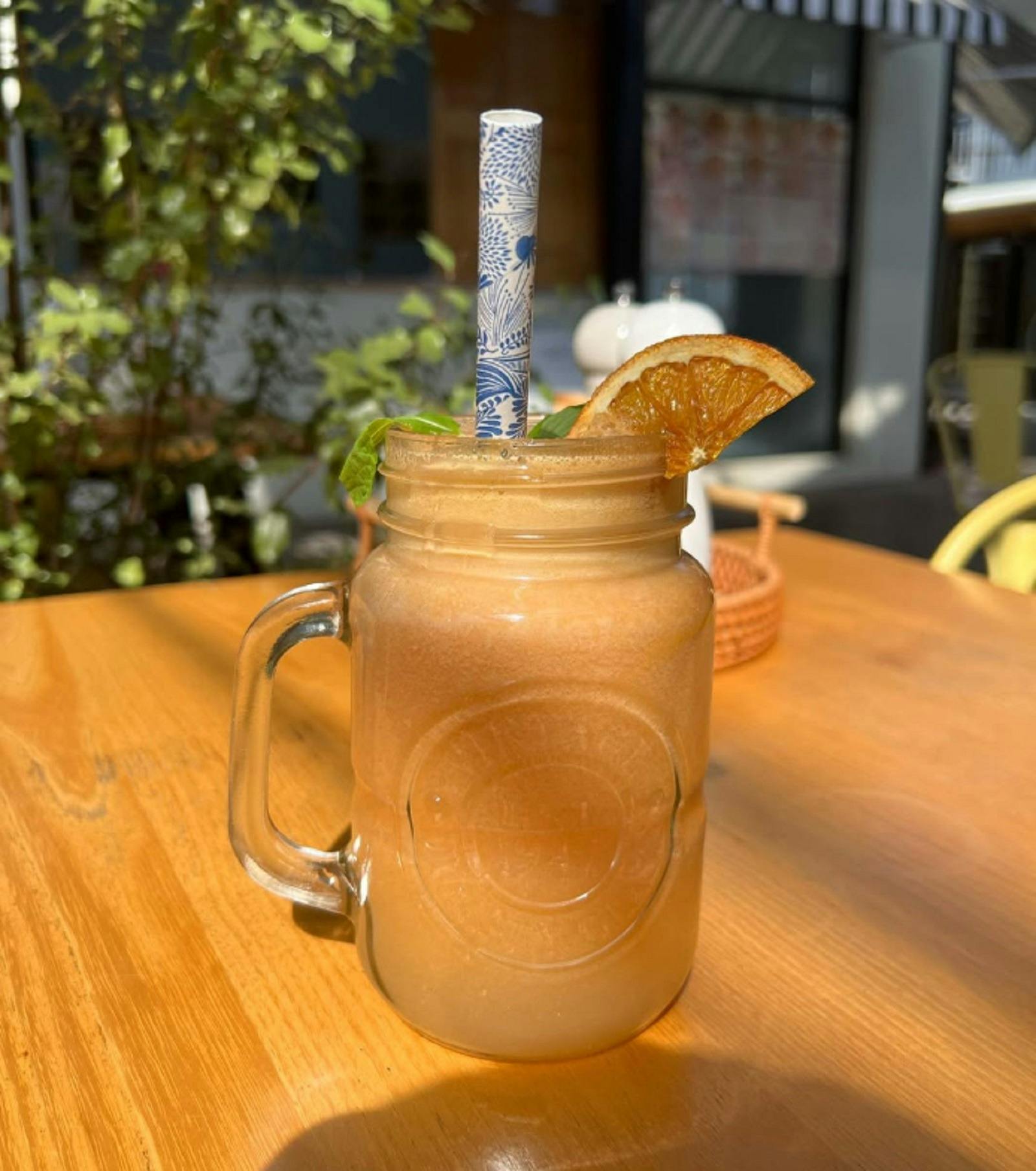 Juice in a glass jug on a table in the sunshine