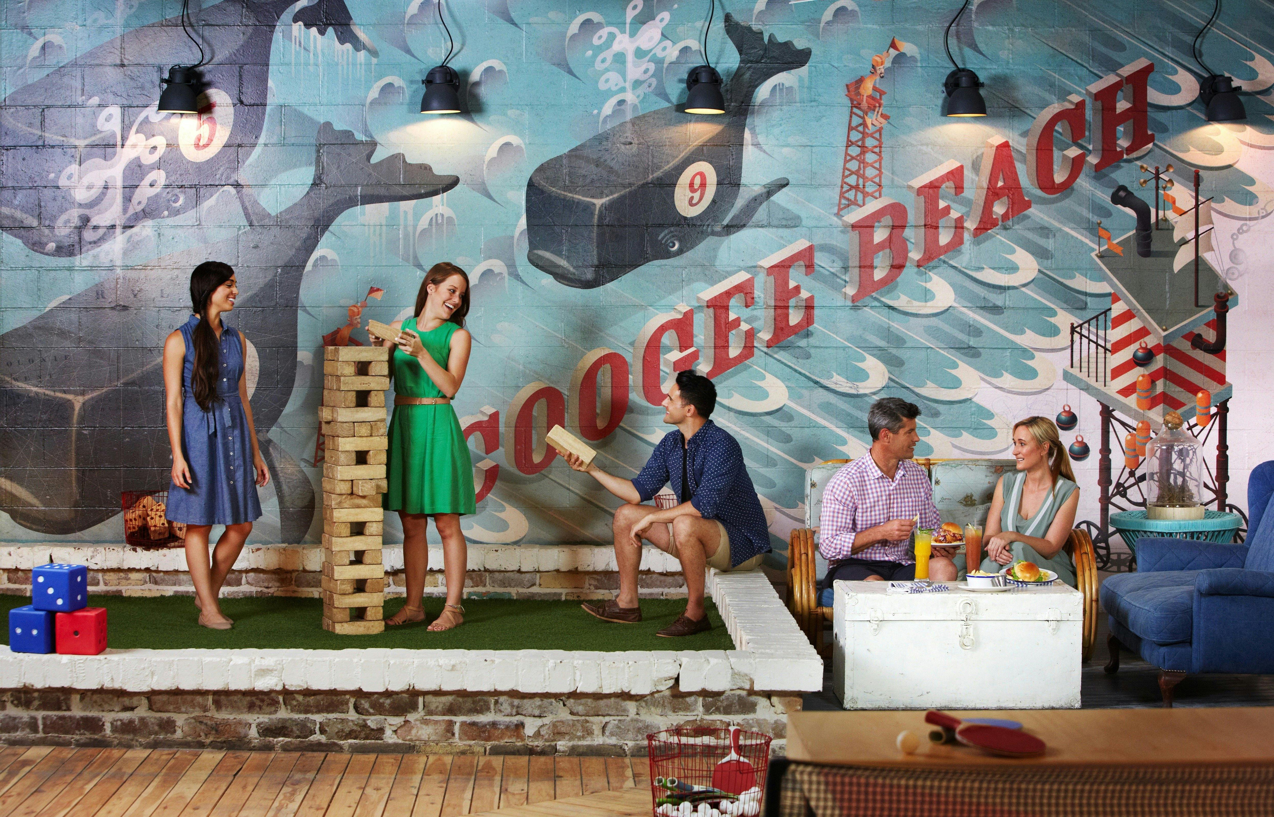 Friends dining and playing Jenga at Coogee Pavilion, Coogee