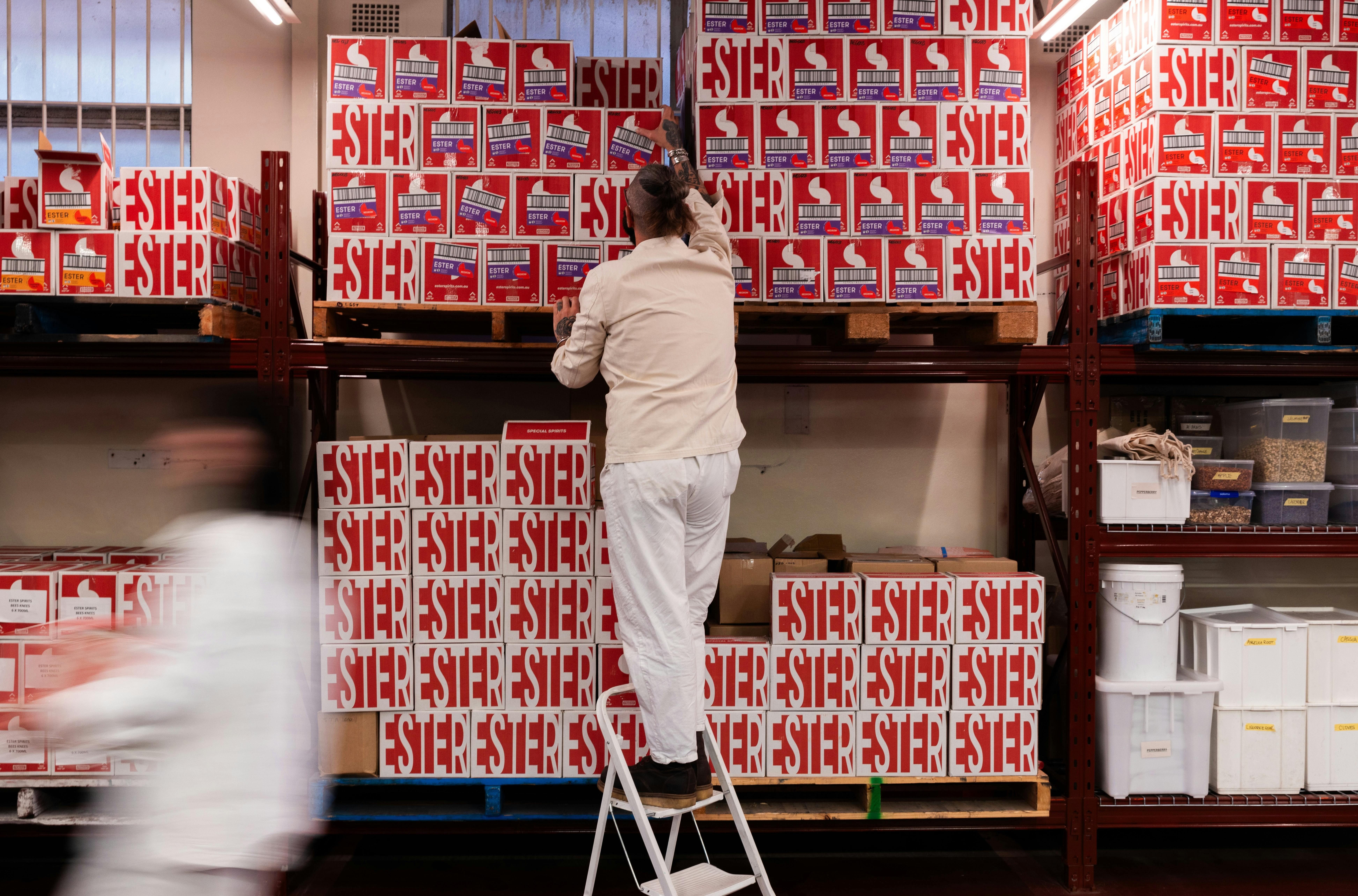 Felix stacking boxed in the distillery