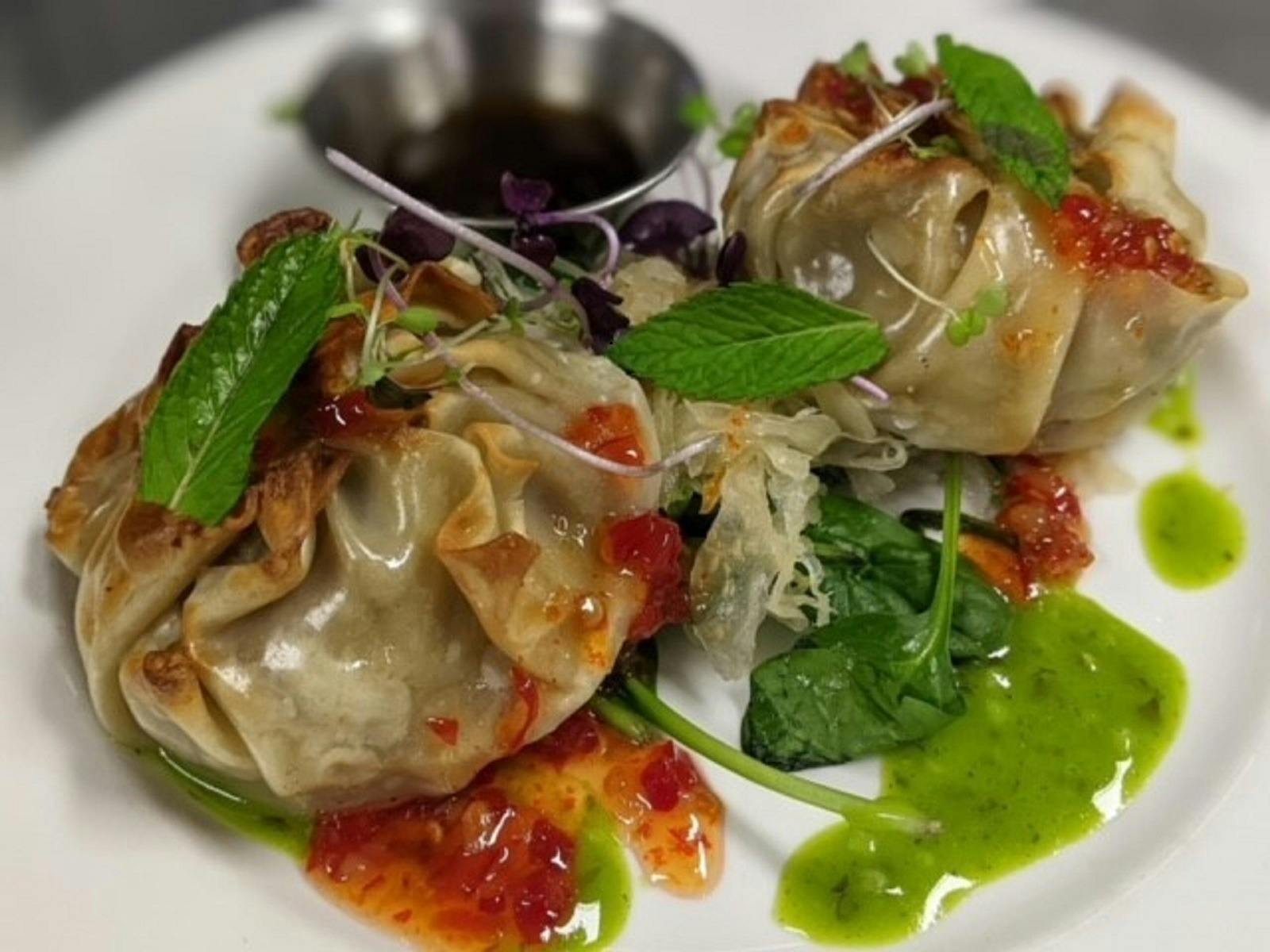 Photo of Homemade Dumplings, garnished and served with dipping sauce