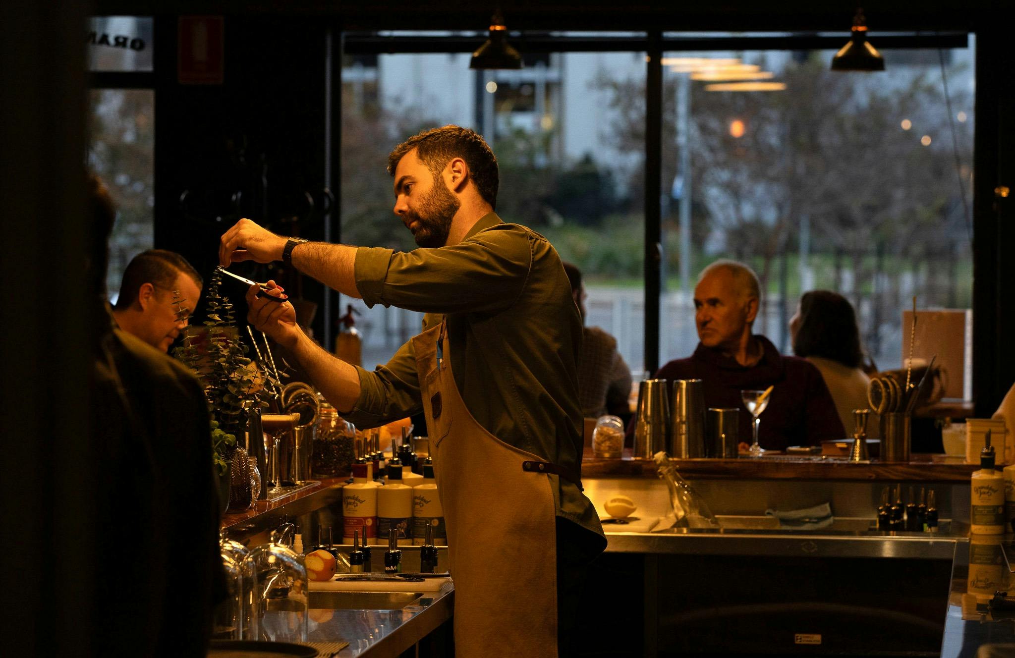 Jimmy, a bartender at Granddad's Bar making cocktails. Making sure every detail is right.