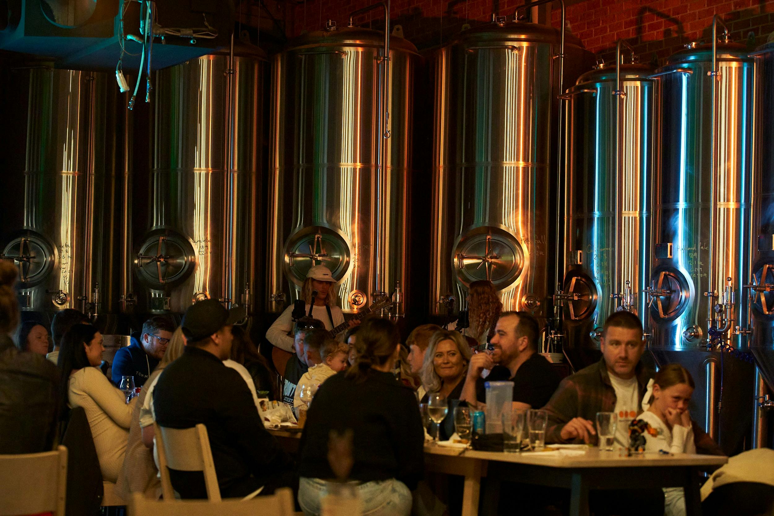 Unwind with a beer at night in the heart of the brewery under the fermenters