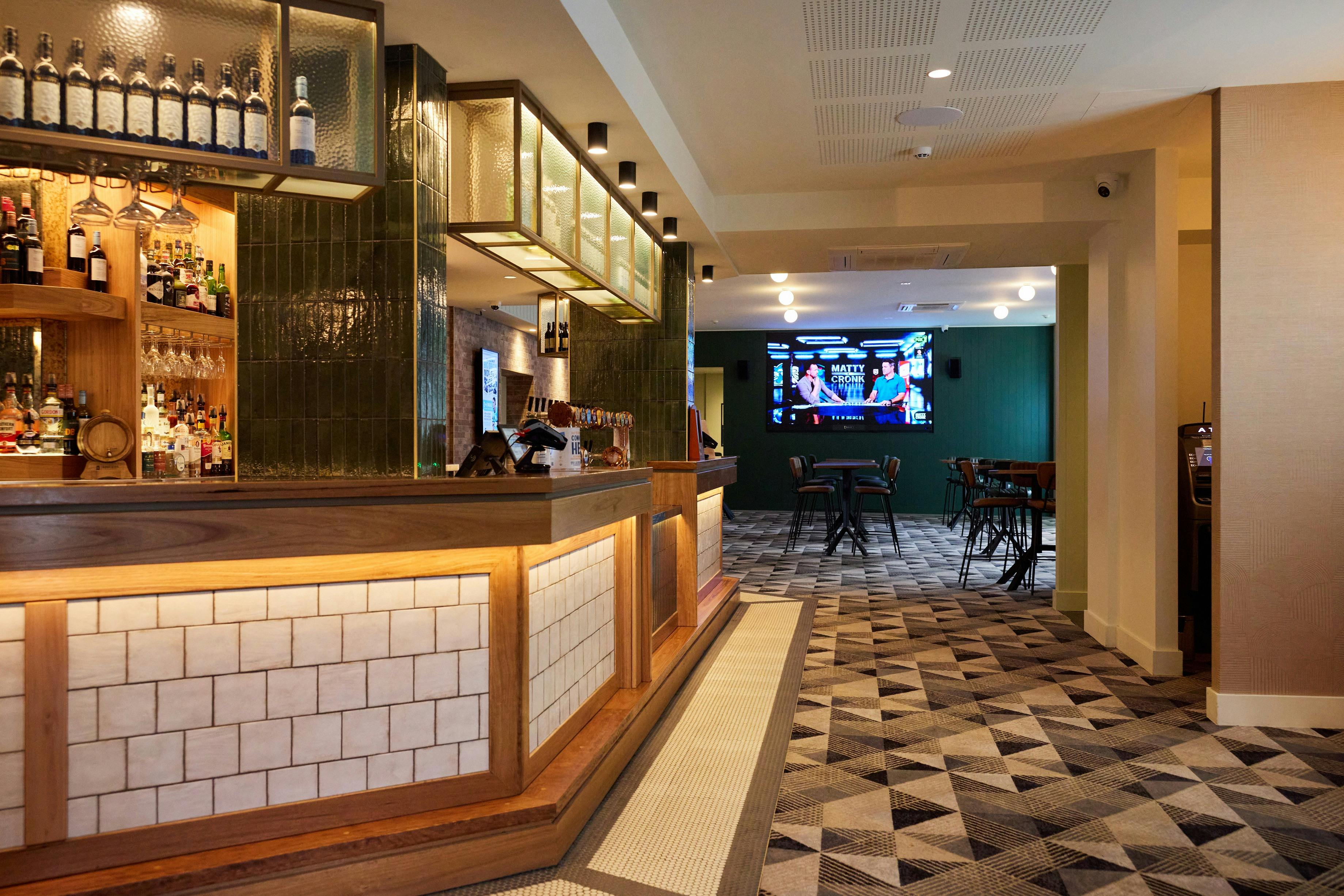 Main bar and giant screen at the Hastings Hotel